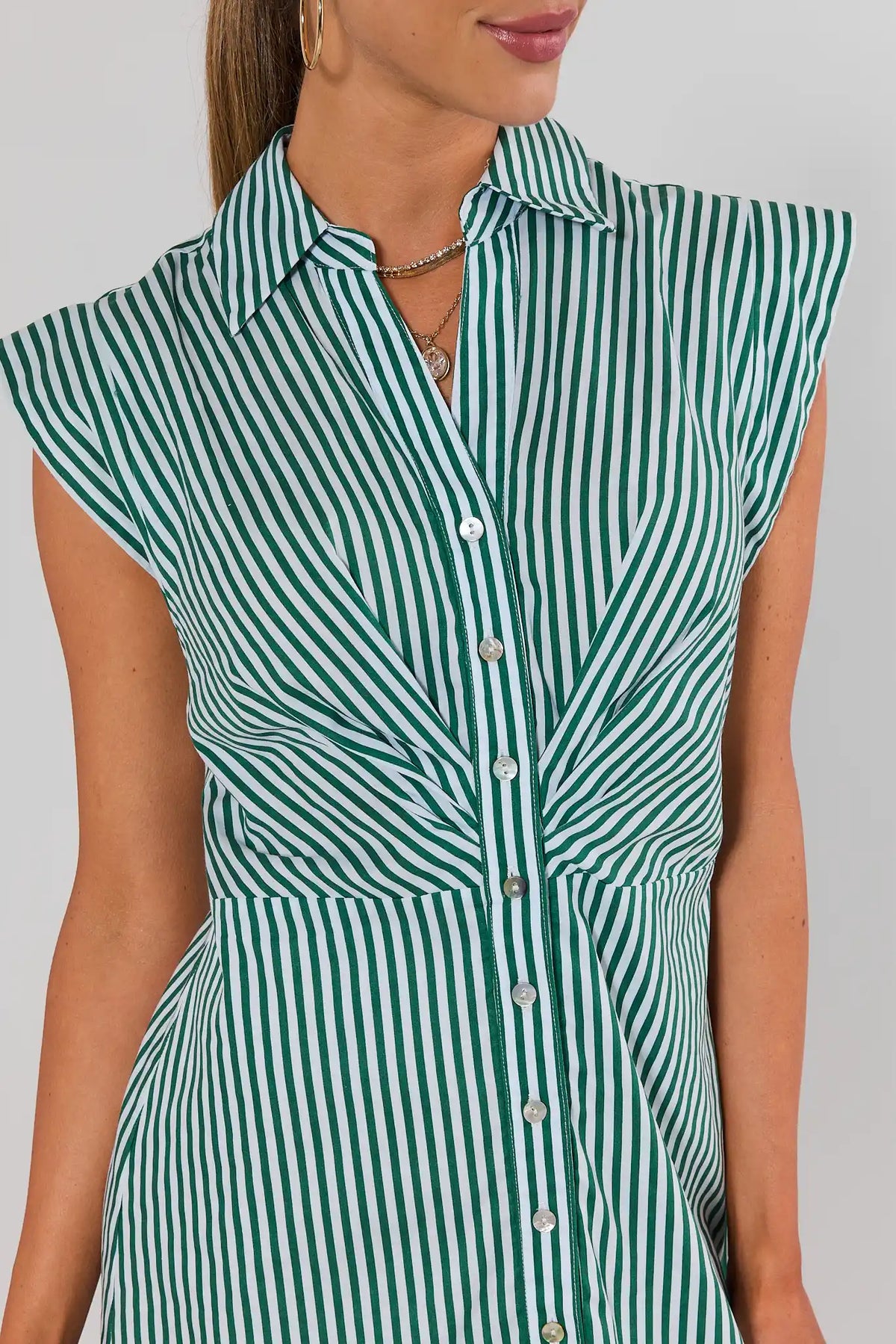 Close-up of green and white striped button-front collared dress bodice with pearl buttons and cap sleeve detail | Avara
