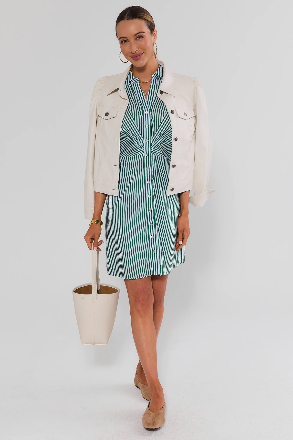 Green stripe short dress styled with cream denim jacket, cream bucket bag, and tan loafers, styled look on model | Avara