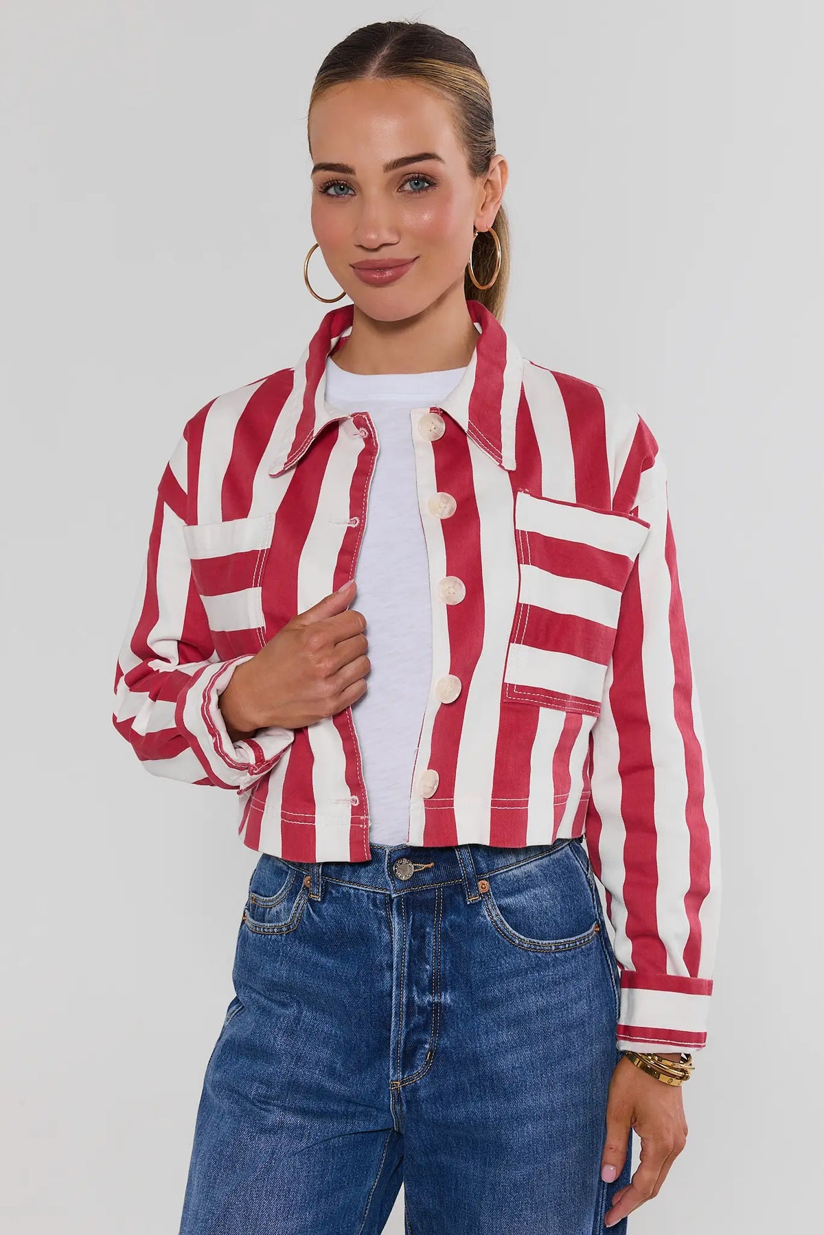 Red and white striped cropped jacket on model, front view, styled over white tee and blue jeans | Avara