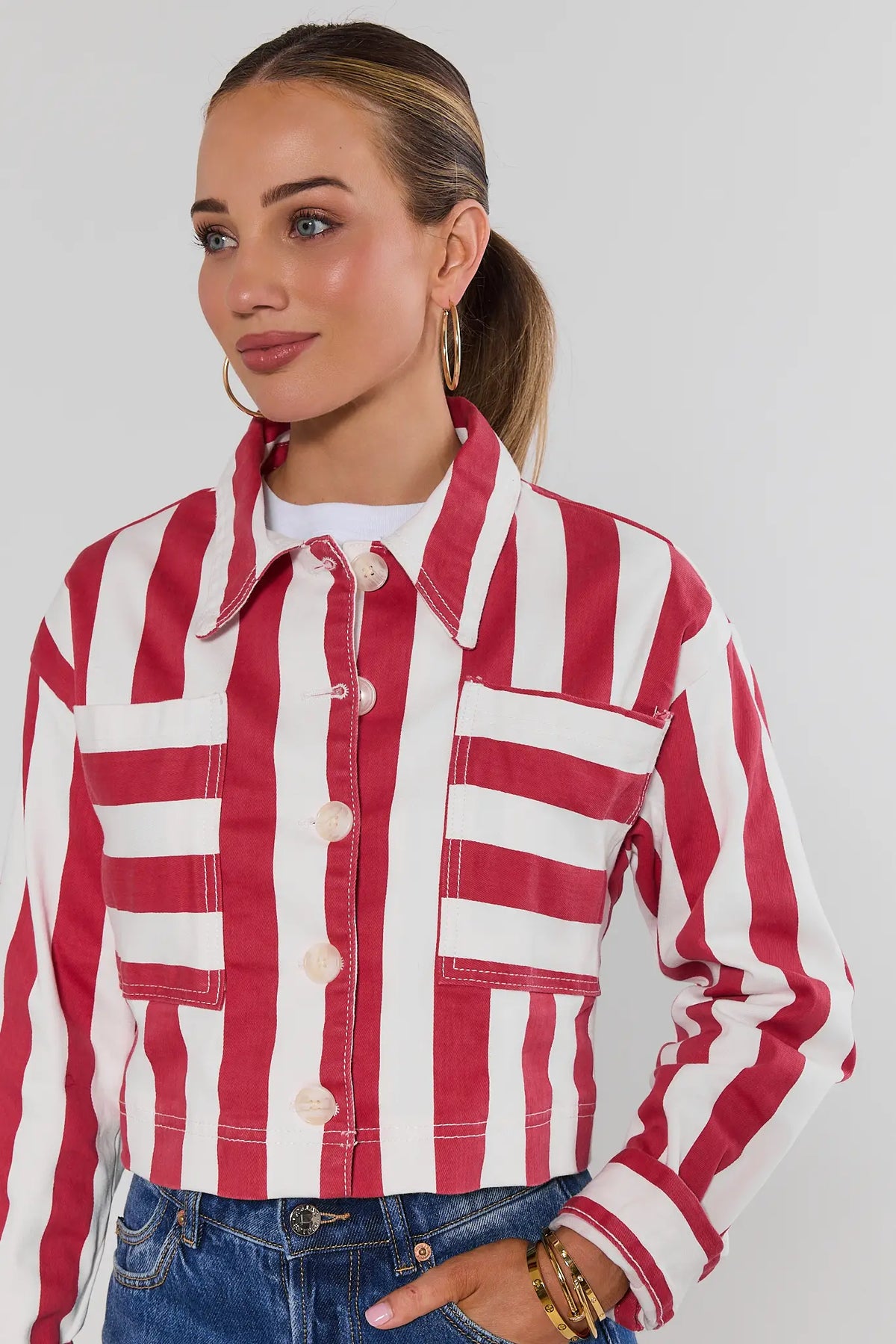 Red striped cropped jacket close-up detail showing button front, chest pockets, and collar | Avara
