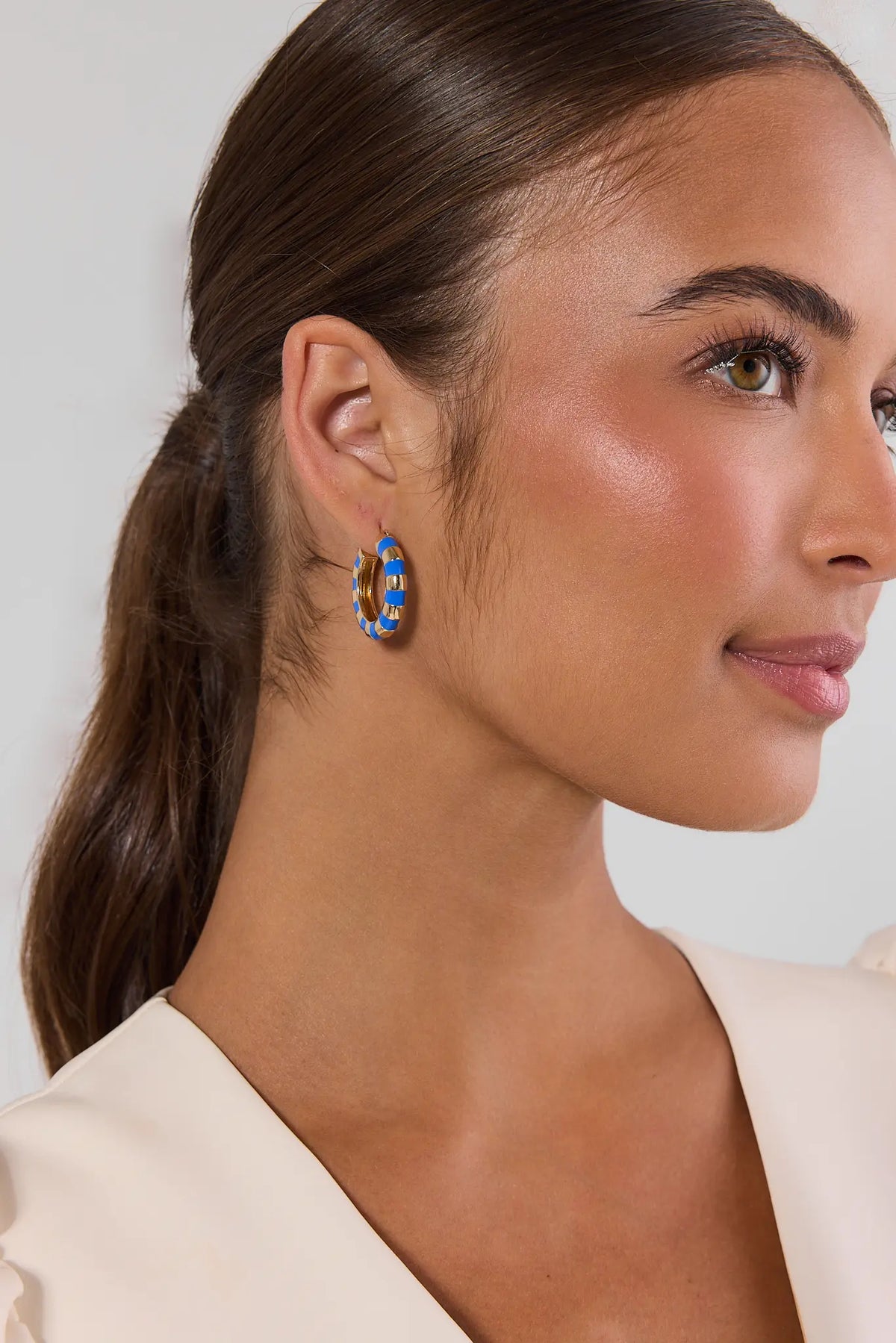 Blue striped gold hoop earring worn by model - Side Profile Close-Up | Avara