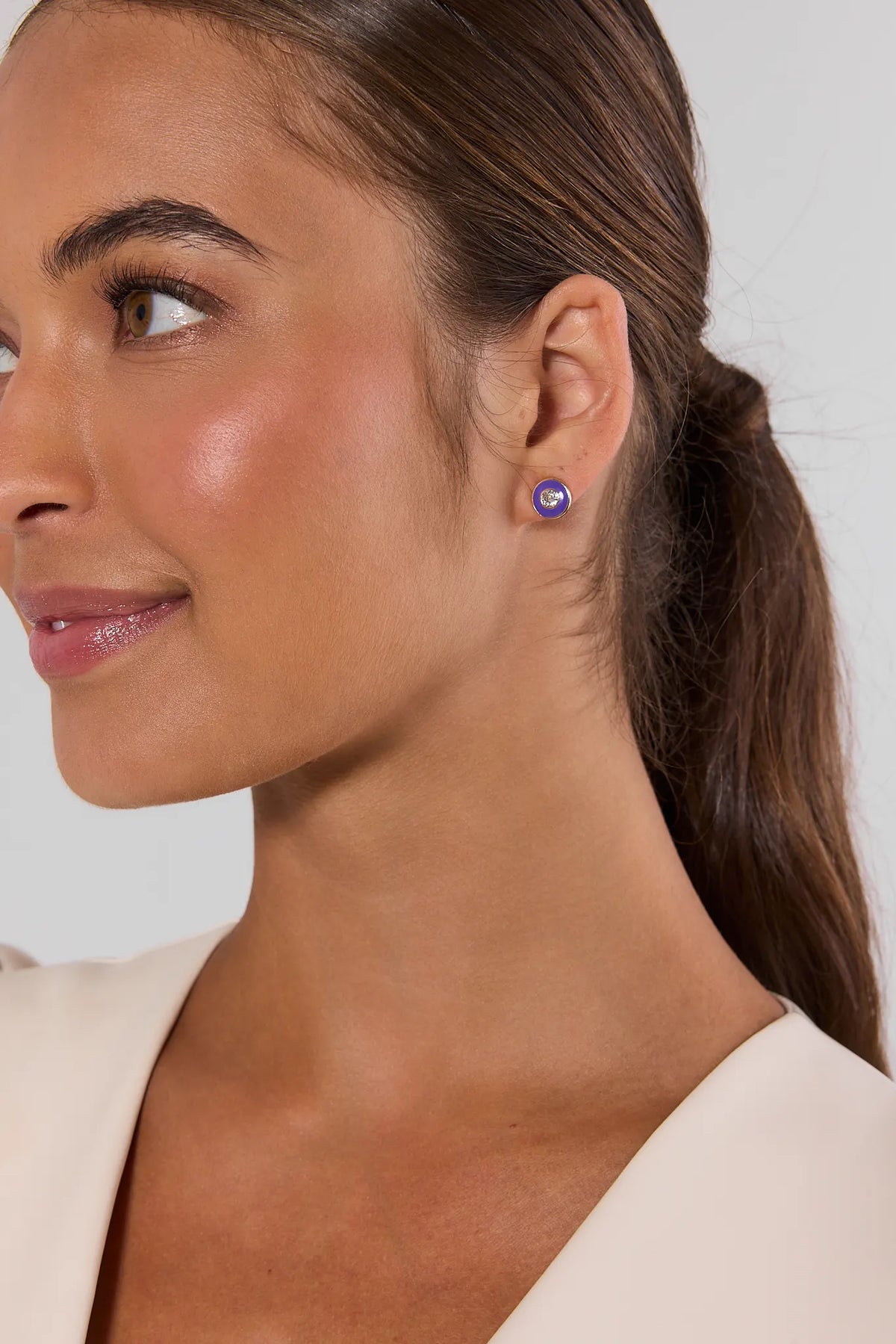 Purple rhinestone stud earring worn by model with brown hair in ponytail - Side Profile | Avara