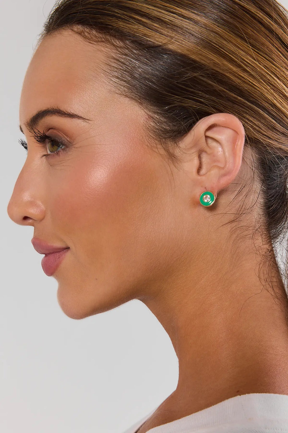 Green enamel rhinestone stud earring with gold rim worn on model - Side Profile | Avara