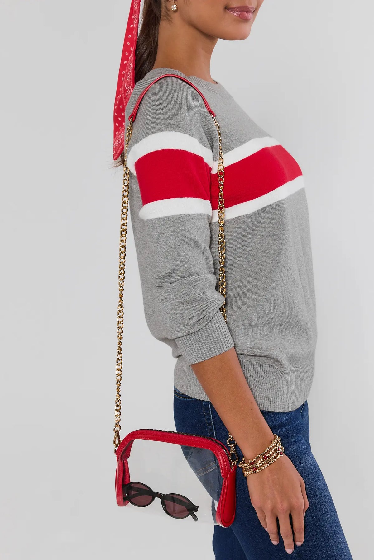 Red clear crossbody bag styled on model with striped sweater and jeans - Game Day Look | Avara