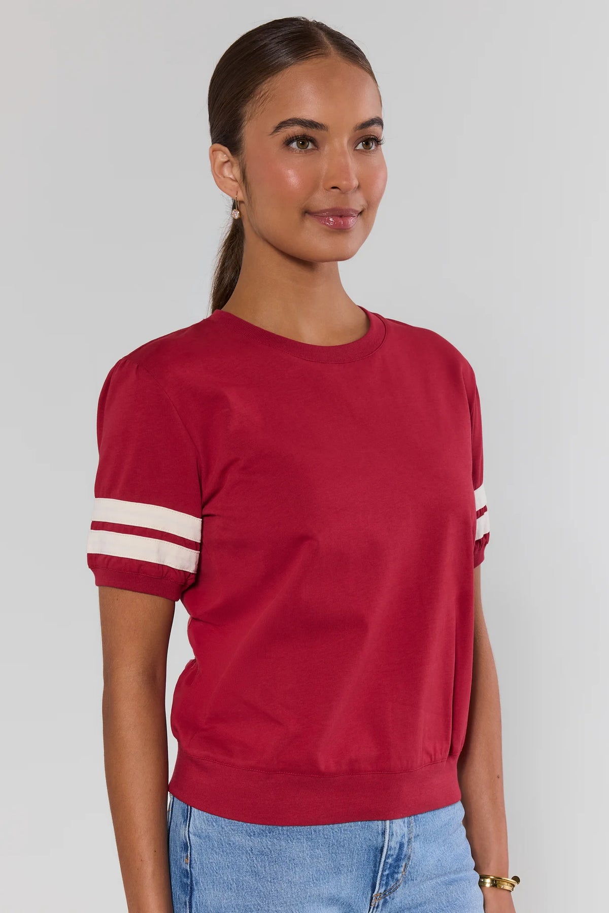 Alice Burgundy Striped Sleeve Tee side profile view showing relaxed silhouette and ribbed hem | Avara