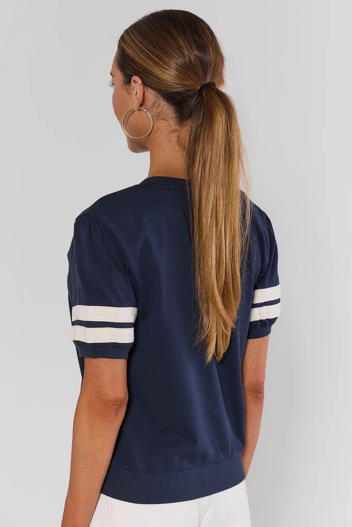 Alice Navy Striped Sleeve Tee - Back View, relaxed silhouette with white varsity stripes on sleeves | Avara