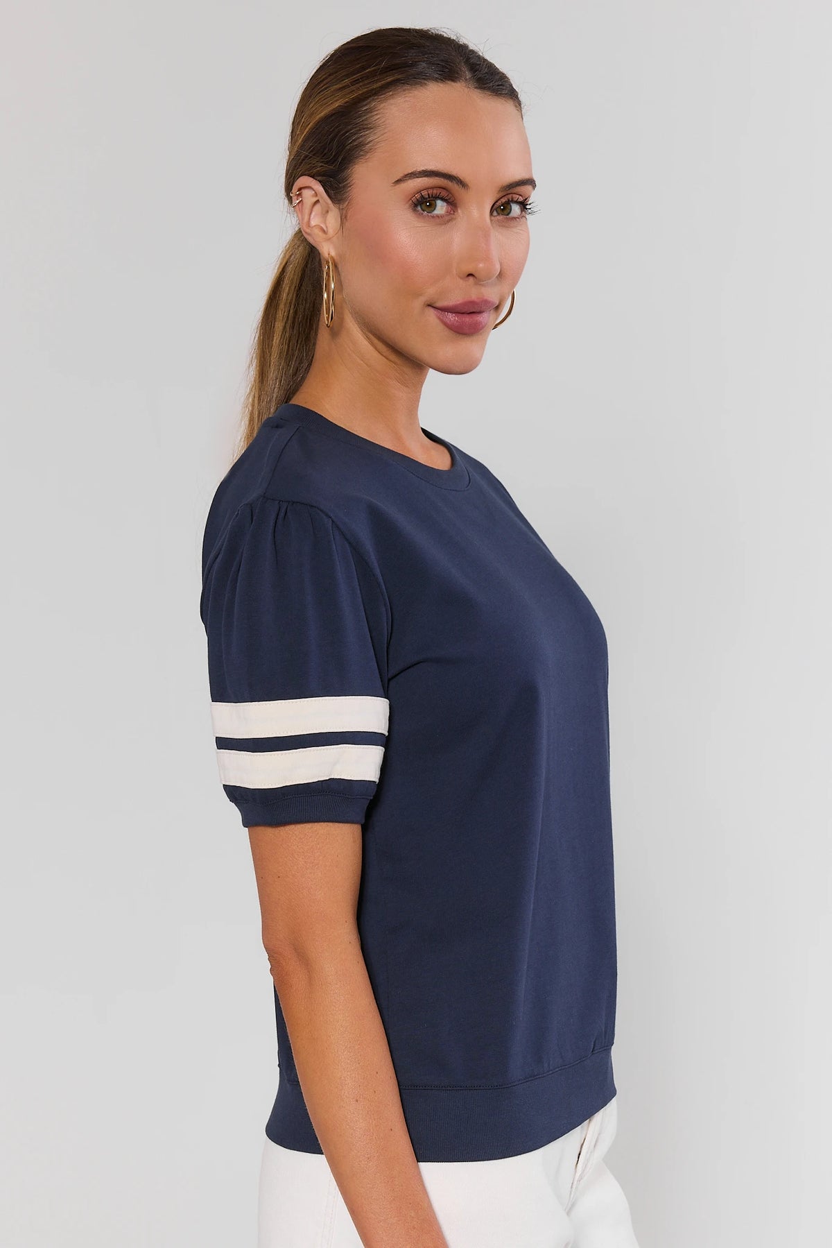 Alice Navy Striped Sleeve Tee - Side Profile View, puff sleeve and varsity stripe detail visible | Avara