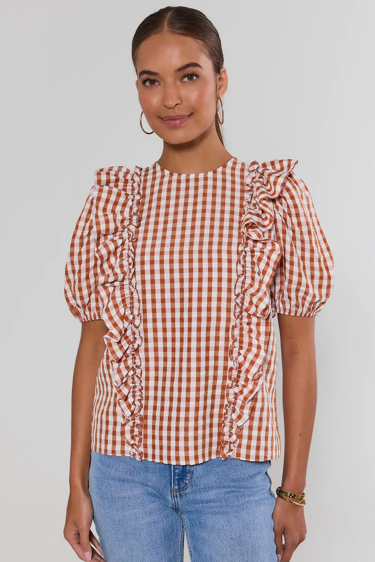 Orange and white gingham ruffle top with puff sleeves and side ruffle trim, styled with light blue jeans | Avara