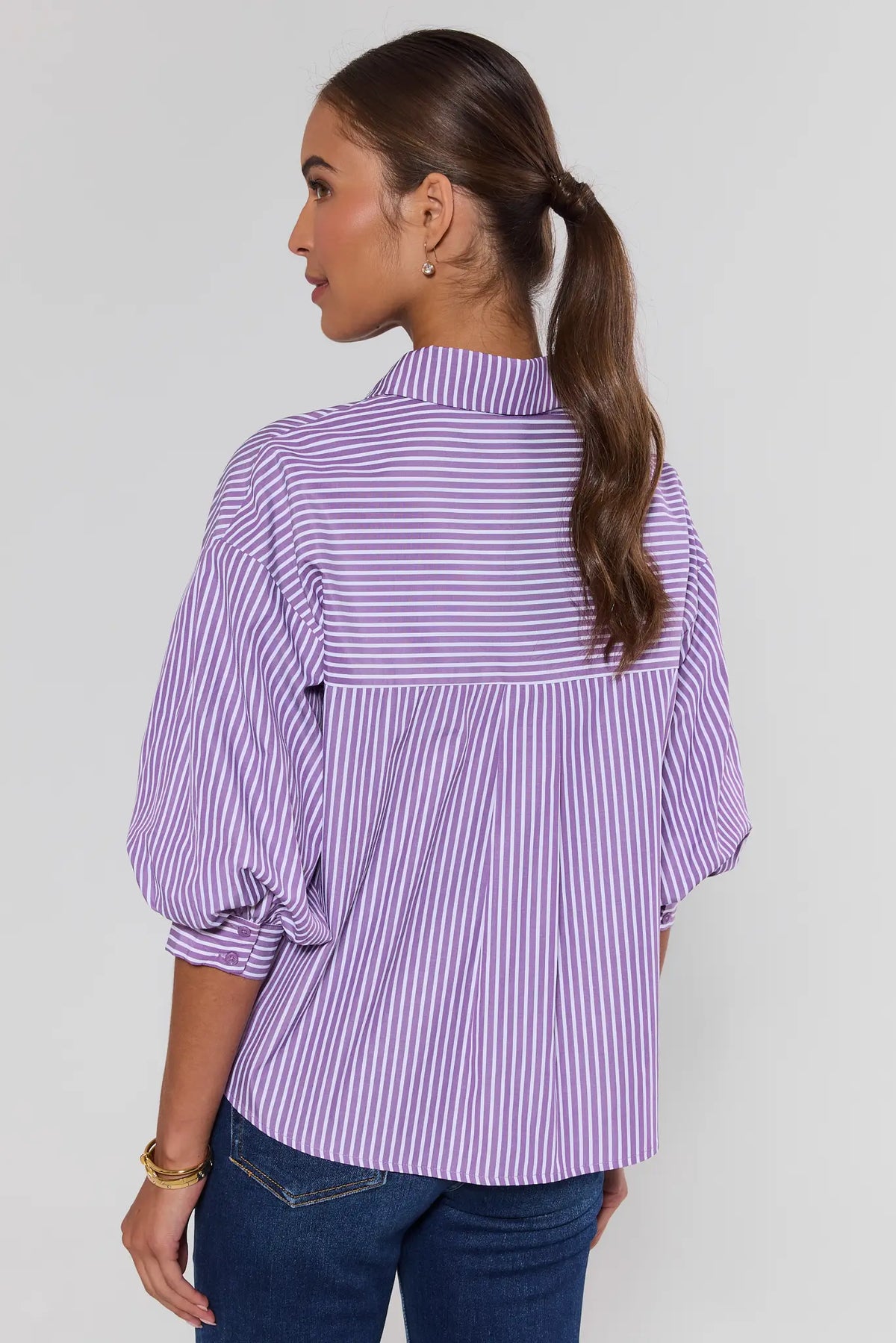 Purple striped button-up top back view showing relaxed silhouette and three-quarter puff sleeves with jeans | Avara