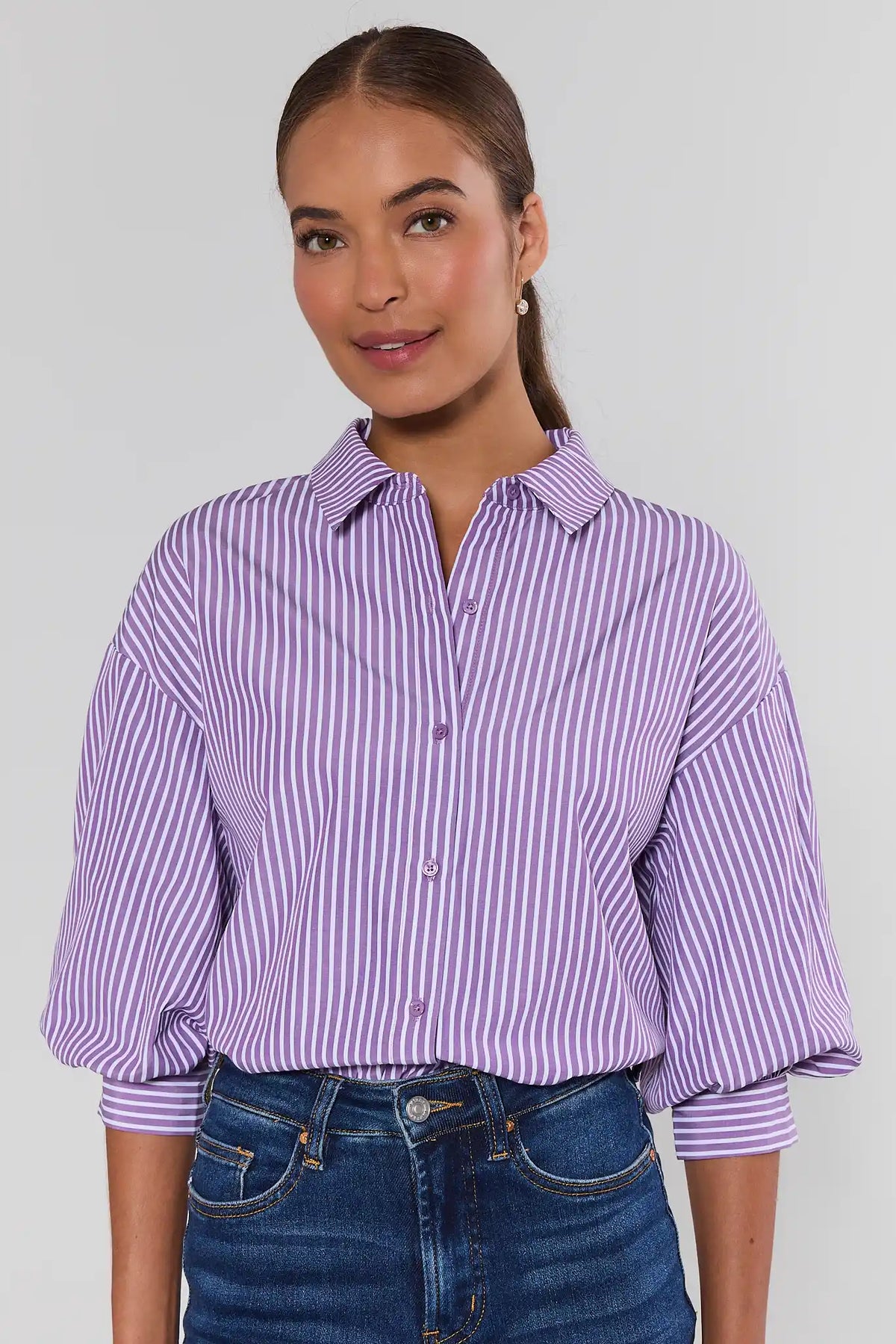 Purple striped button-up top with spread collar and three-quarter sleeves, styled with blue jeans - Front View | Avara