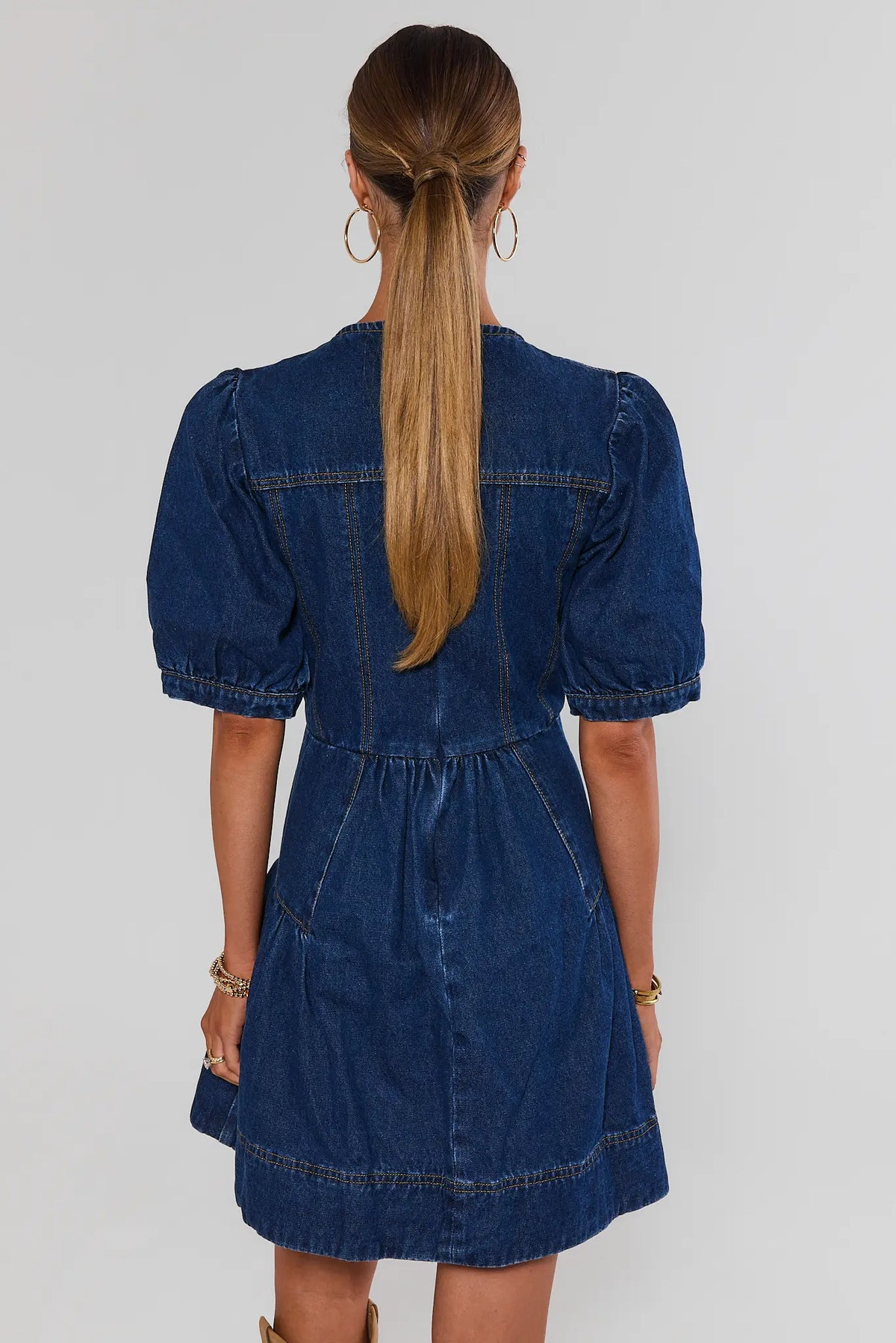 Dark denim puff-sleeve short dress showing back seam detail and A-line silhouette - Back View | Avara