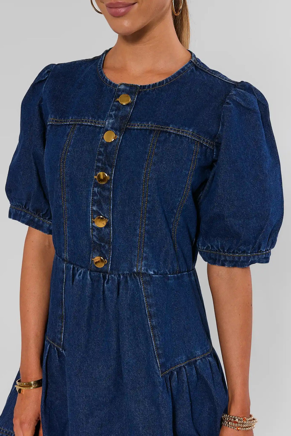 Dark denim A-line short dress with puff sleeves and gold button-front bodice - Close-Up Detail | Avara