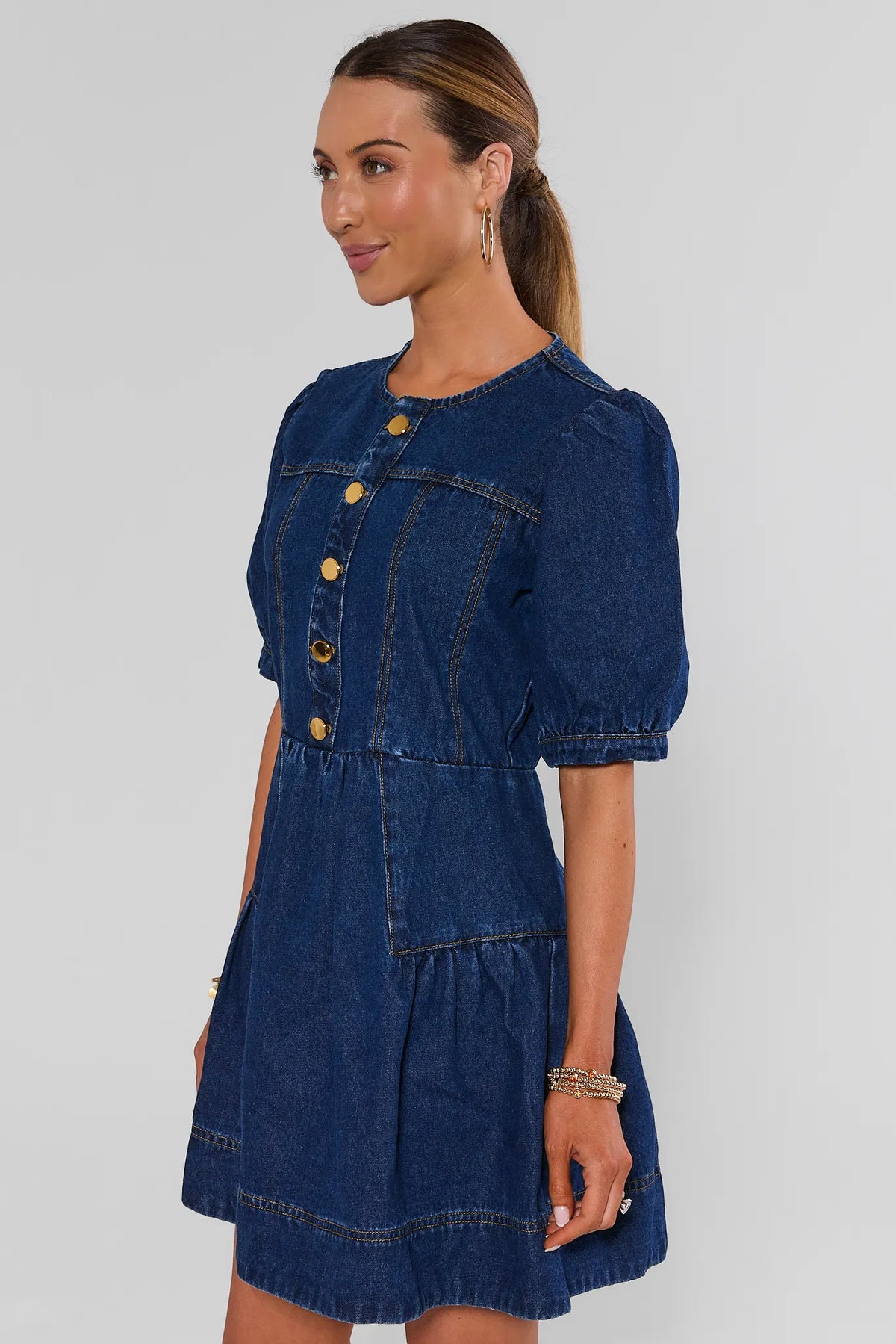 Dark denim puff-sleeve mini dress with tiered skirt and gathered waist - Side Profile View | Avara