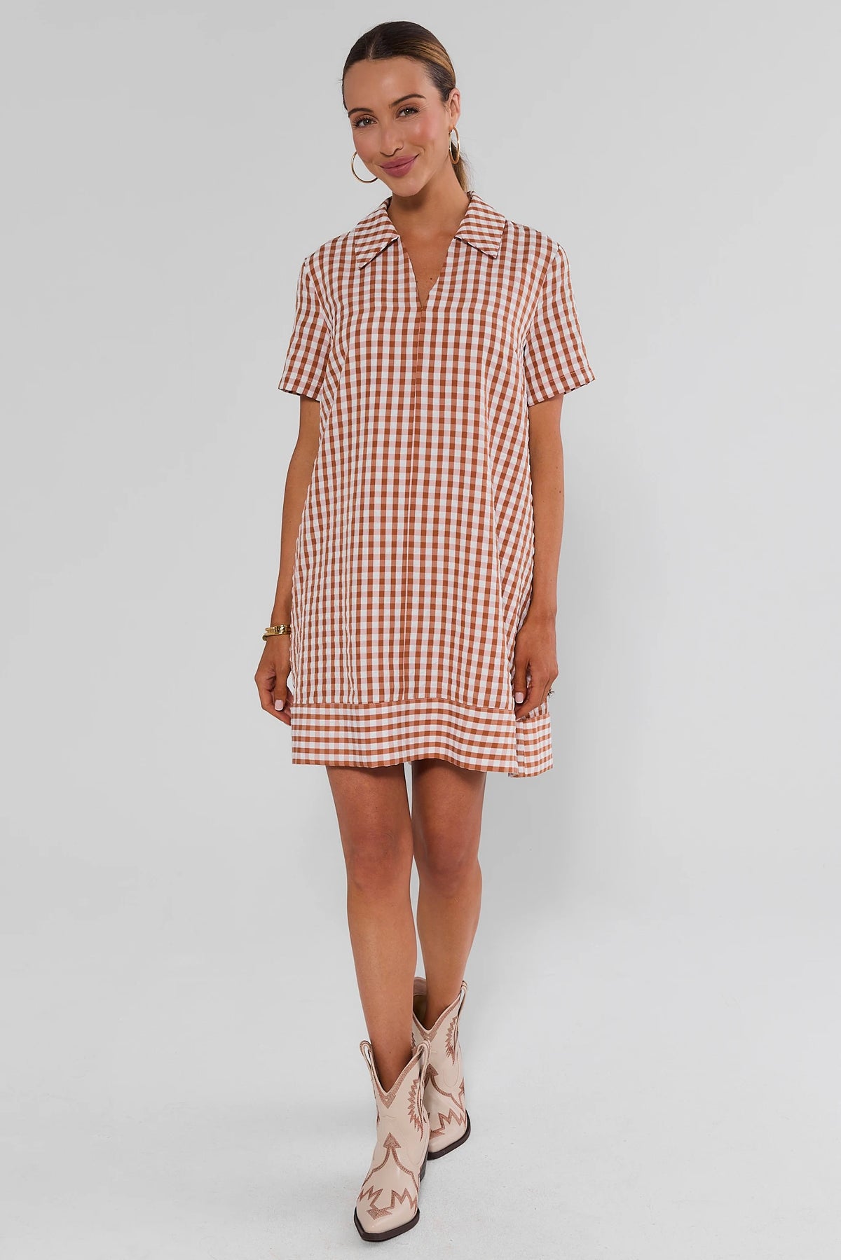 Tia Rust Gingham Collared Short Dress - Full Length, styled with cream cowboy boots for game day | Avara