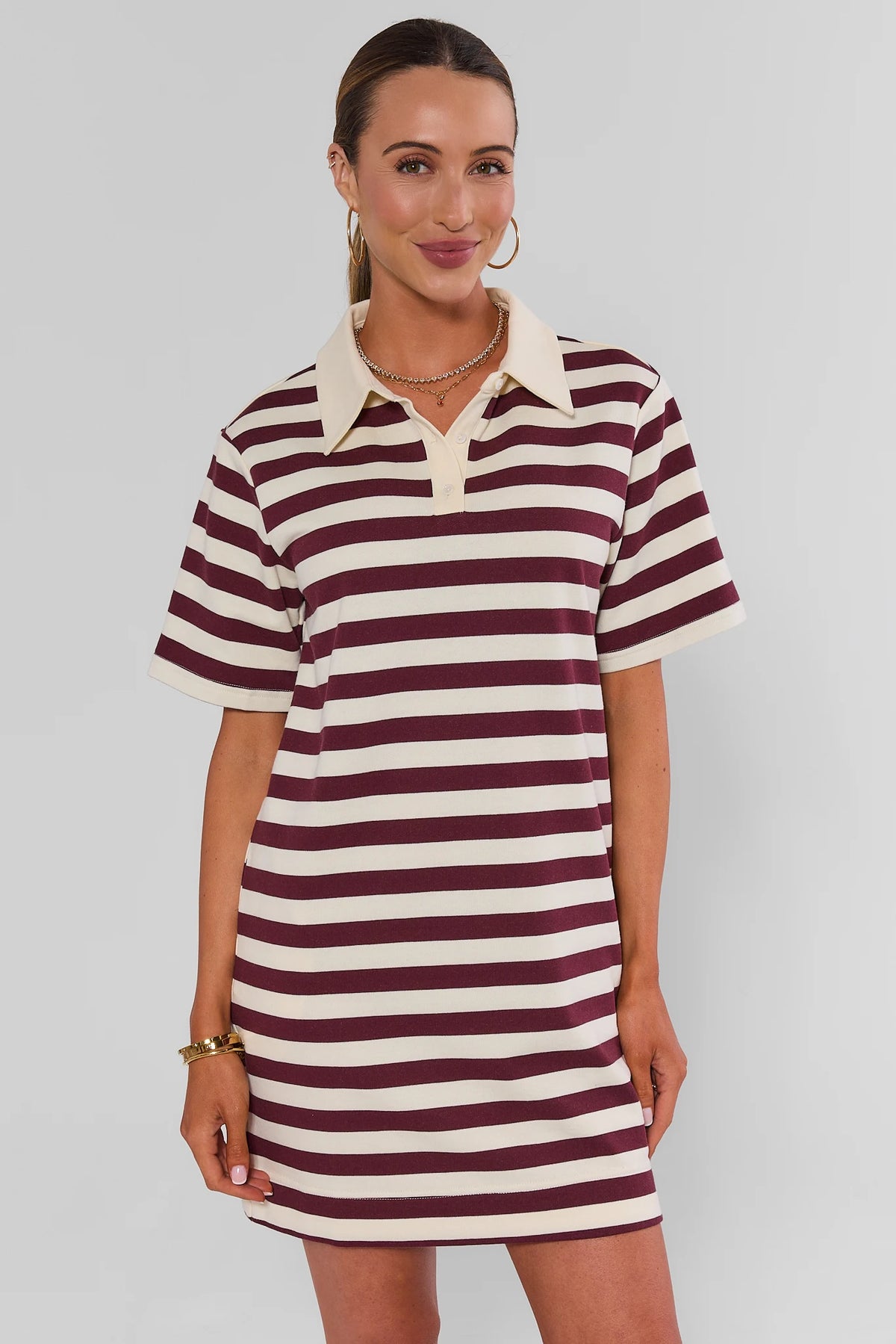 Maroon and cream striped short polo dress with cream collar, front view on model | Avara