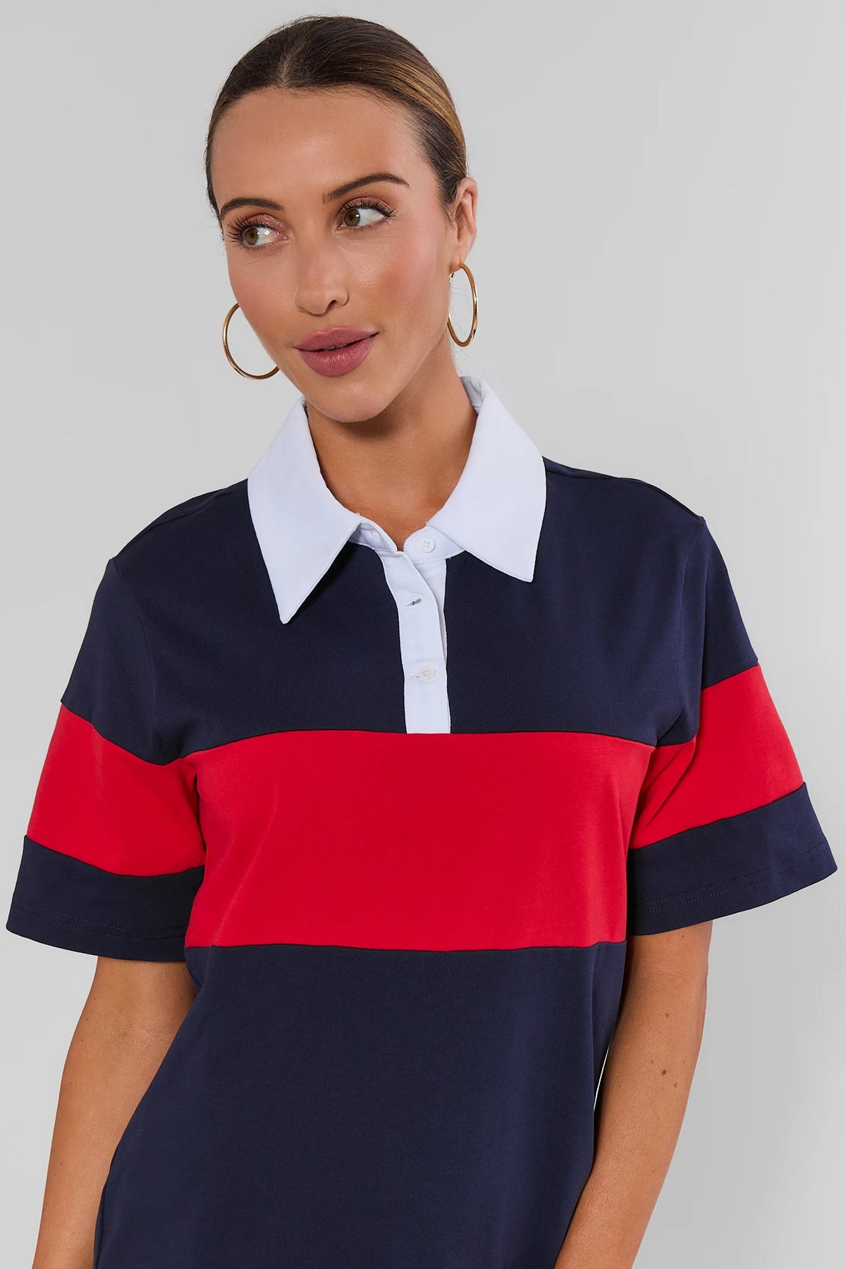 Navy striped polo dress close-up showing white collar, button placket, and red chest stripe - Detail View | Avara