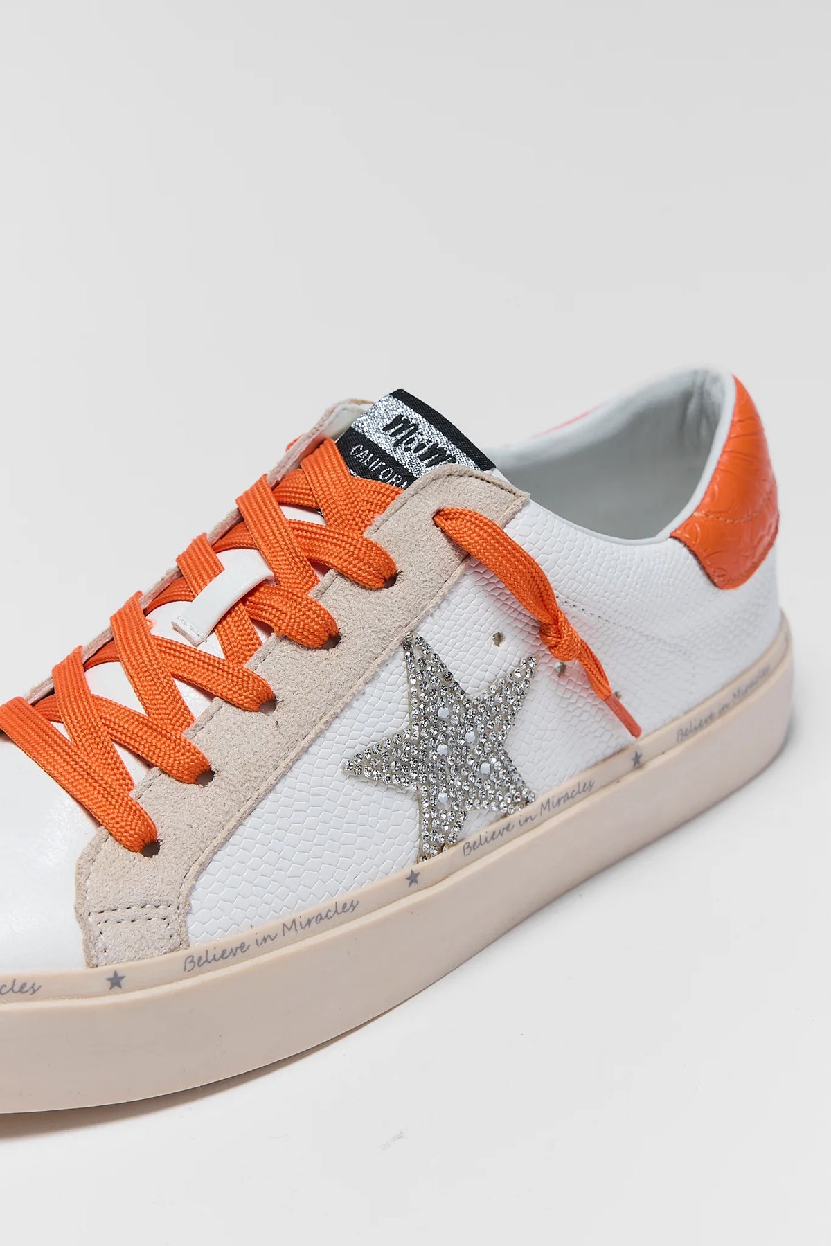 White sneaker with rhinestone silver star and orange laces - Close-Up Star Detail | Avara