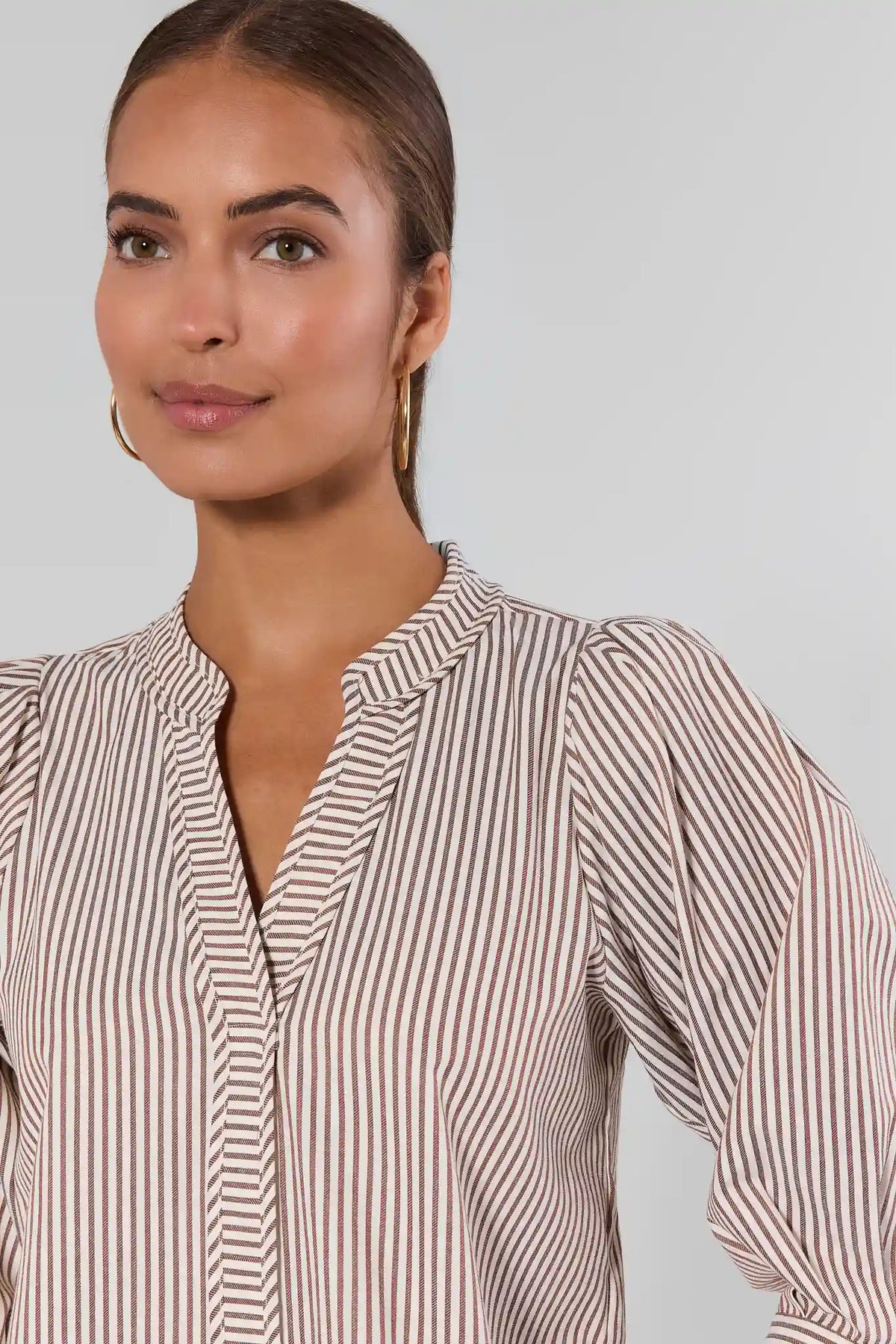 Thea Brown Striped Puff Sleeve Top - Close-Up Neckline & Puff Sleeve Detail | Avara