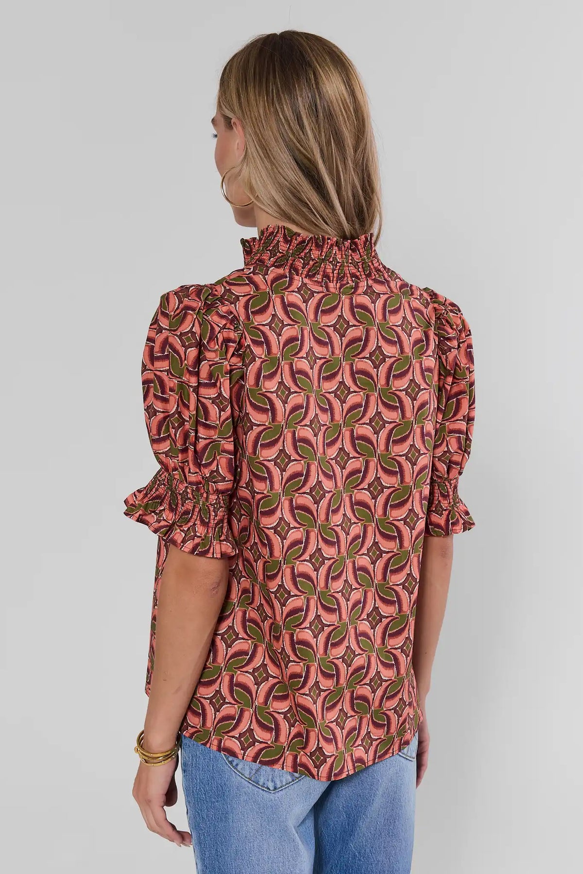 Edith Brown Printed Contrast Trim Top with smocked high neck and puff sleeves, styled with blue jeans - Back View | Avara