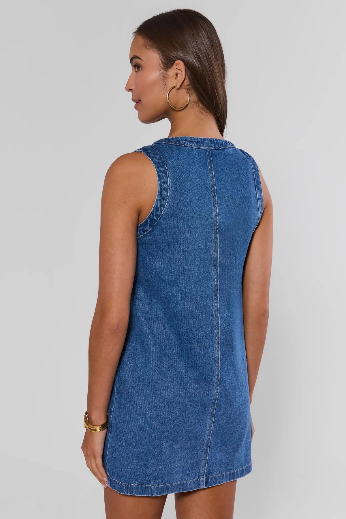 Blue denim button-up short dress showing clean back seam and relaxed silhouette - Back View | Avara