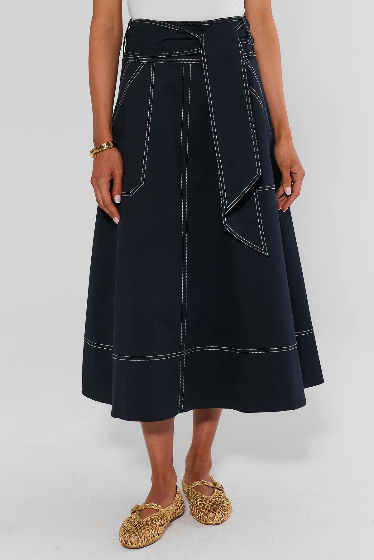 Navy Charlotte Tie Waist Midi Skirt with white contrast stitching and front patch pockets - Front View | Avara