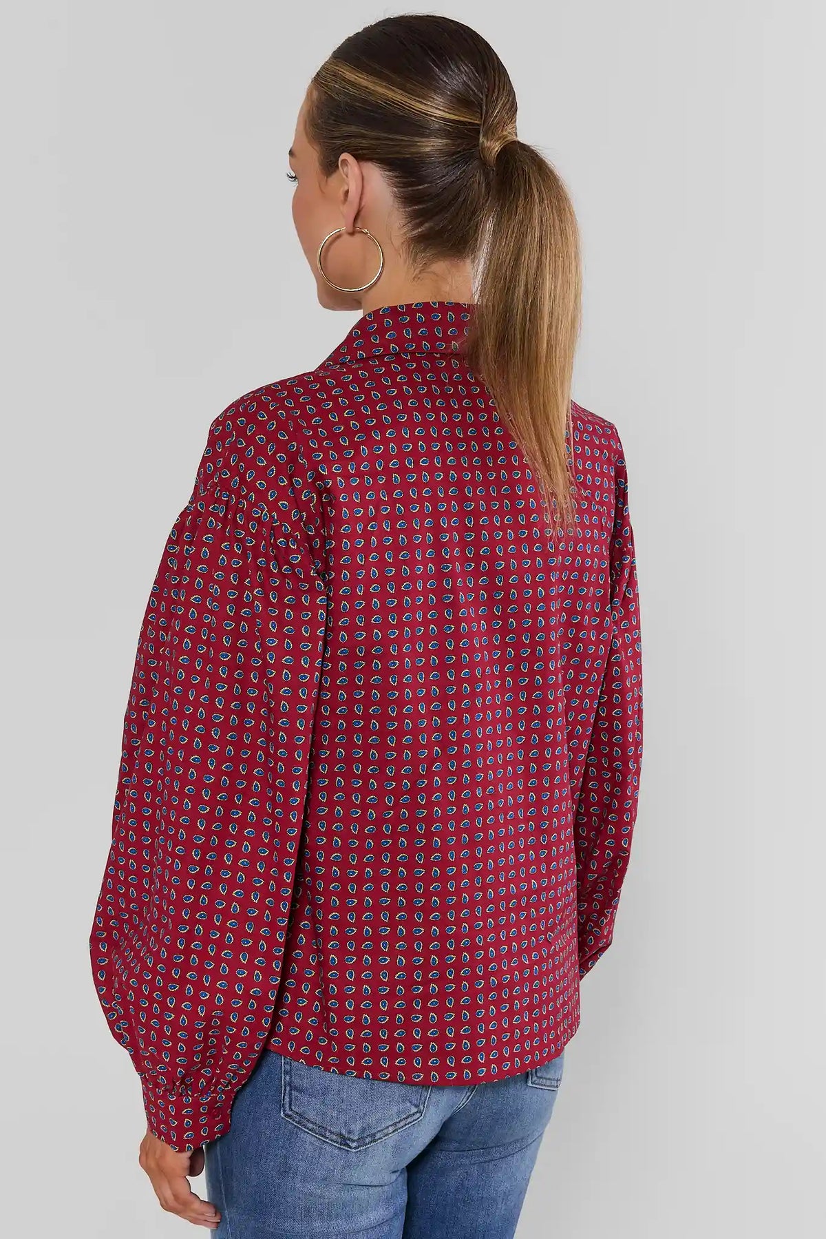 Maroon micro-paisley printed button-up top with voluminous long sleeves, paired with blue jeans - Back View | Avara