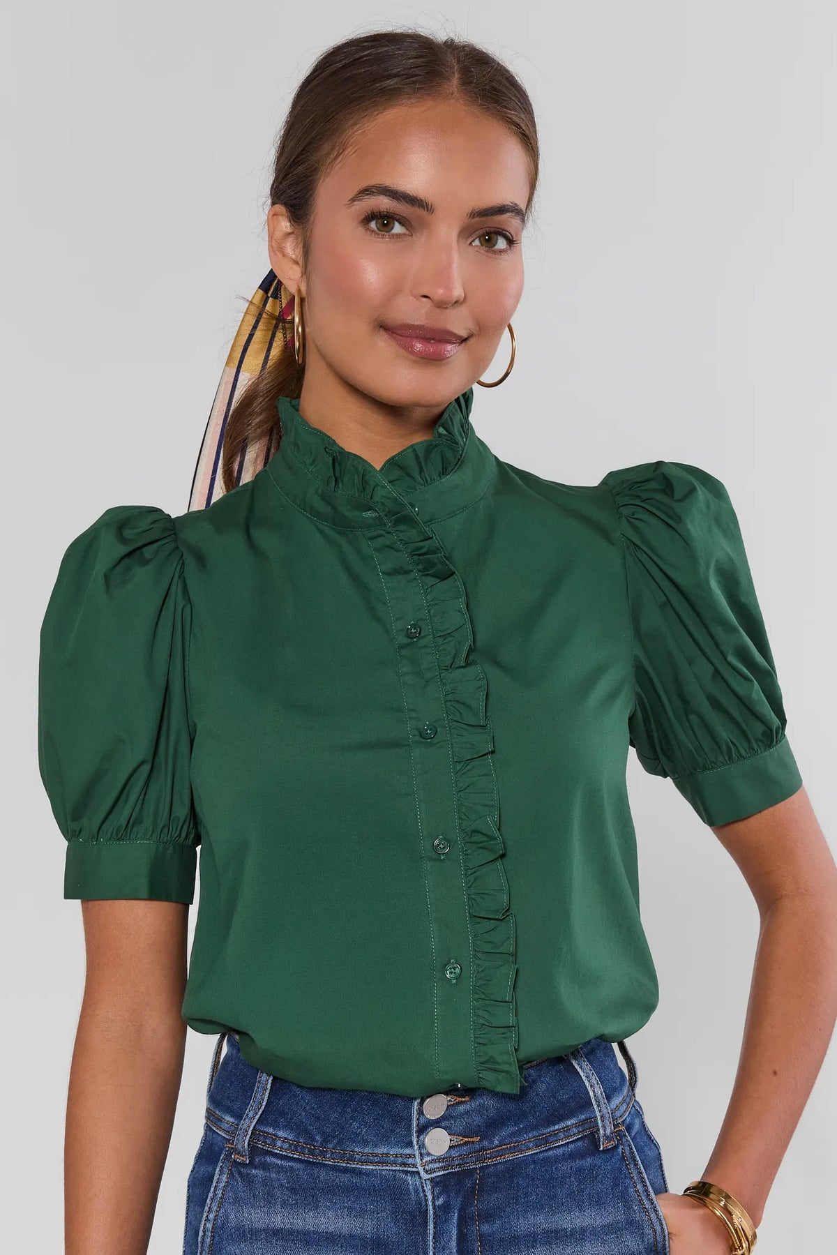 Green Ruffle Detail Button Up Top with puff sleeves and ruffled collar, styled with blue jeans - Front View | Avara