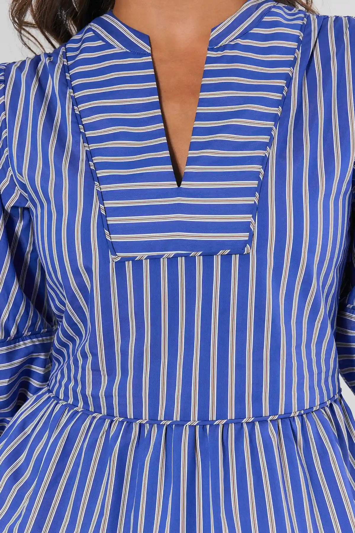 Close-up of blue striped peplum top split V-neckline and peplum hem detail | Avara
