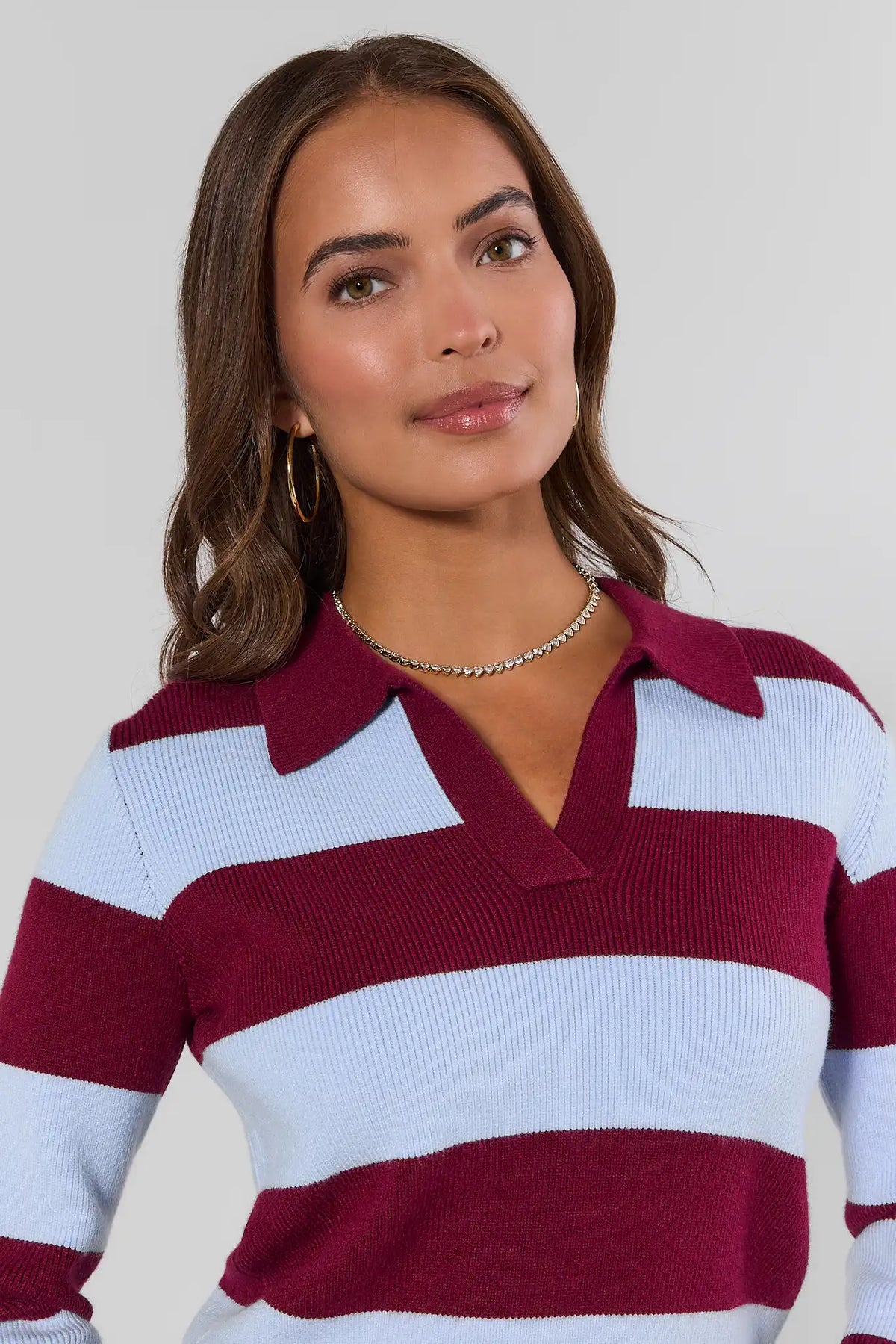 Close-up of maroon striped sweater polo collar and V-neckline detail, ribbed knit fabric with open neckline | Avara
