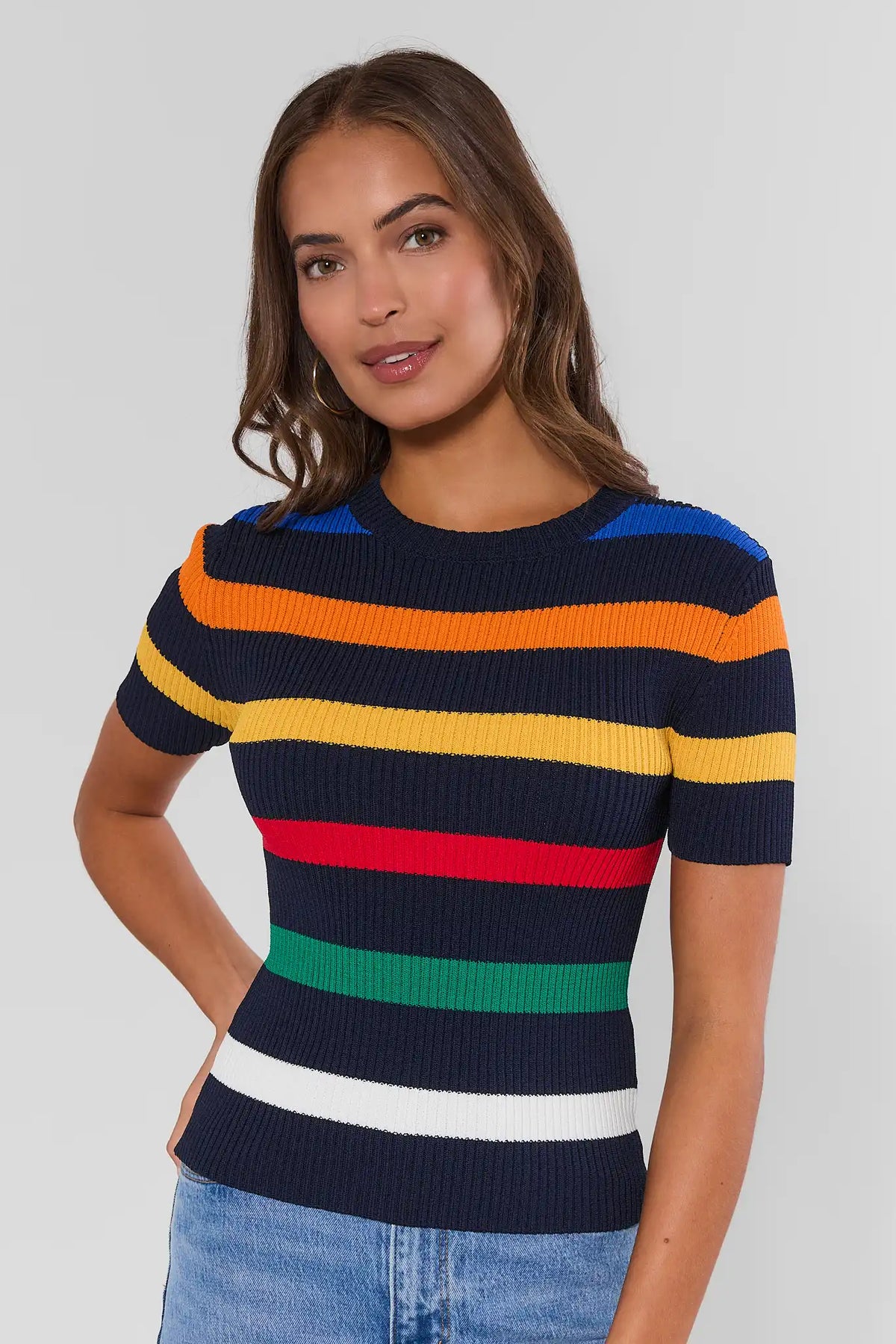 Multi-striped ribbed knit top in navy with orange, yellow, red, green stripes - Front View, on model with light-wash jeans | Avara