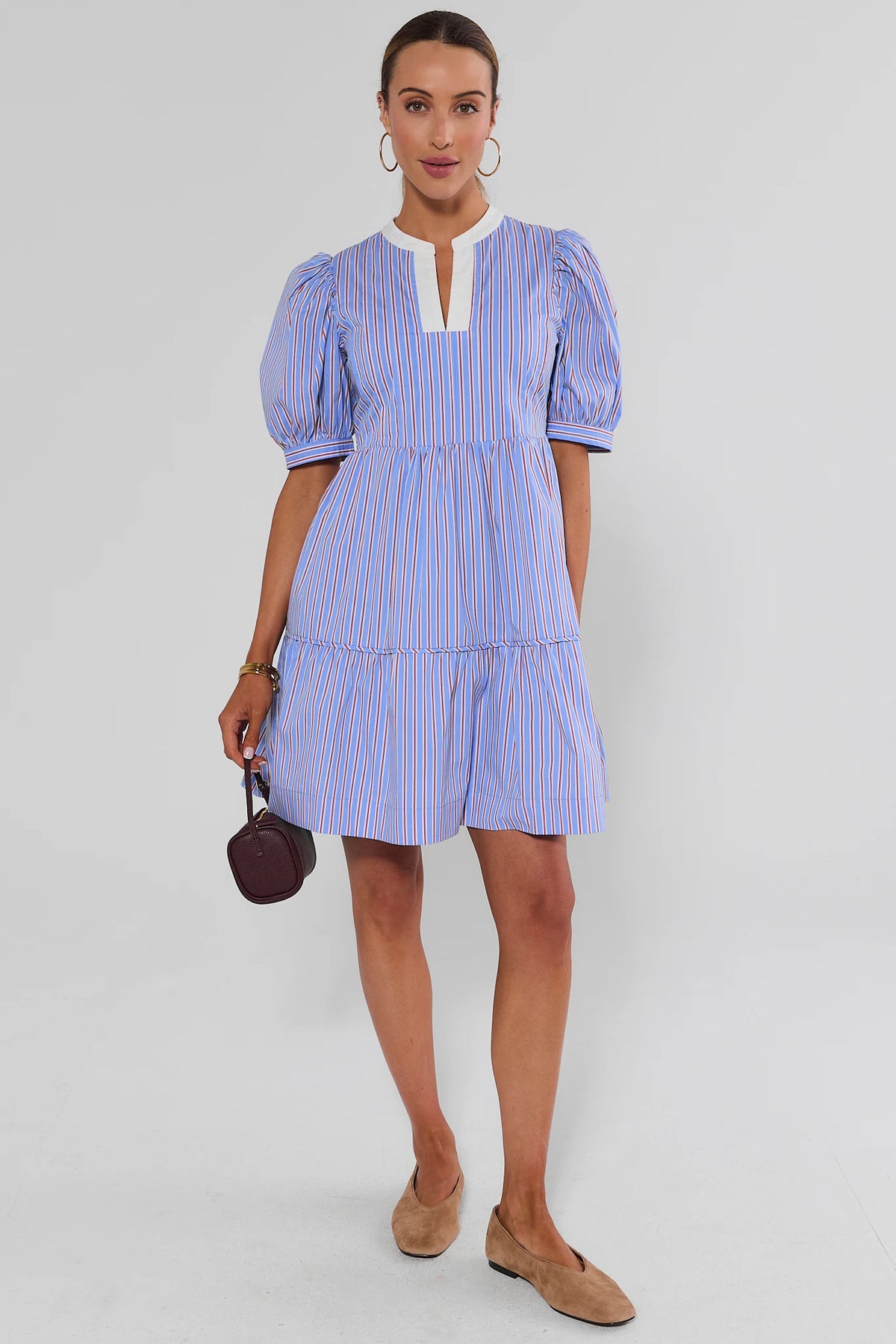 Blue striped tiered short dress styled with tan loafers and dark mini bag, full-length front view | Avara