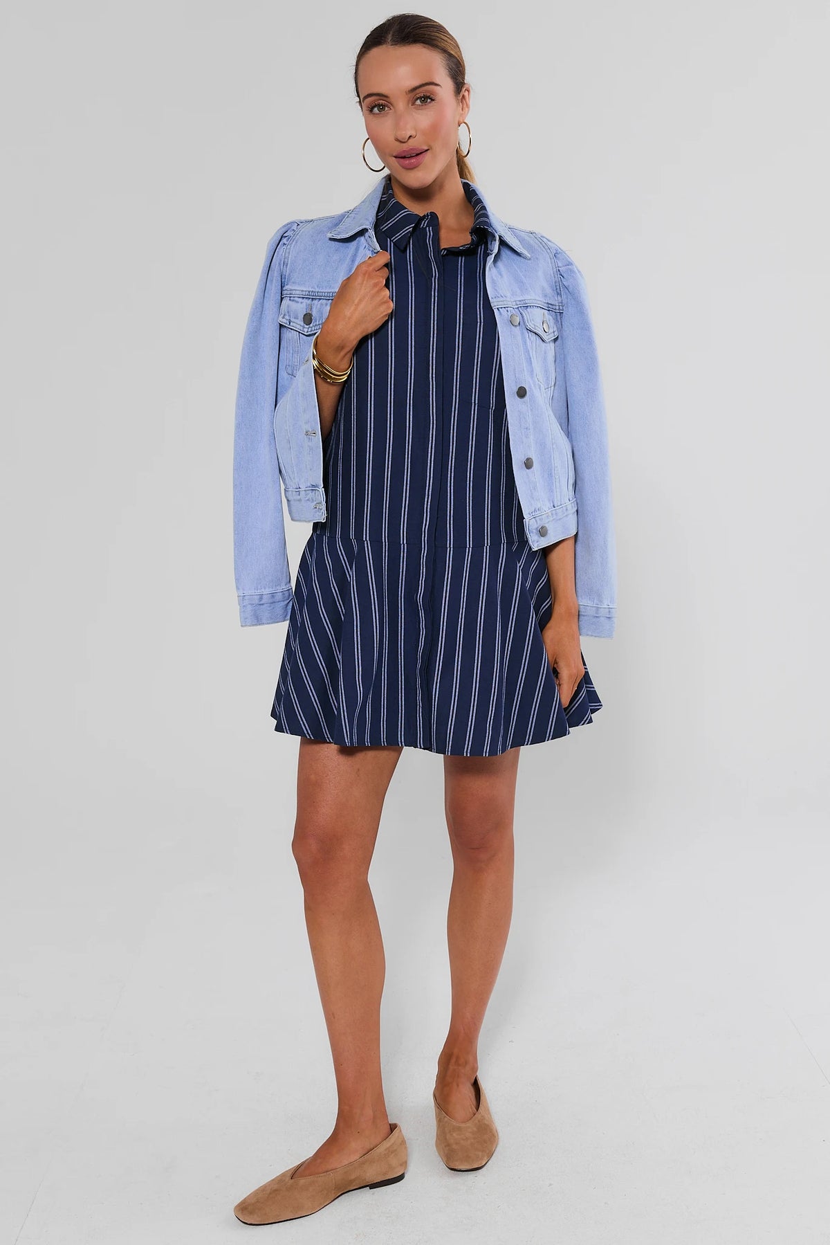 Navy striped short dress styled with light wash denim jacket and tan loafers, full styled look | Avara