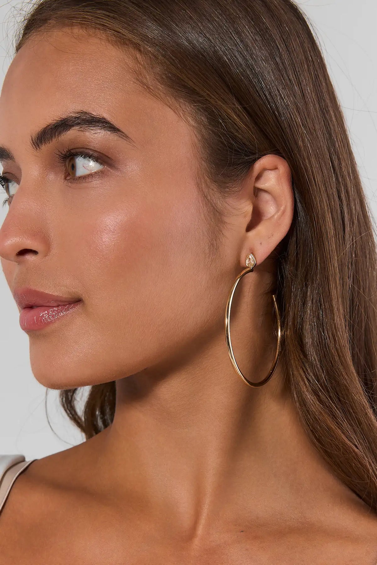 Gold Rhinestone Thin Hoop Earrings styled on model with rhinestone stud - Side Profile | Avara