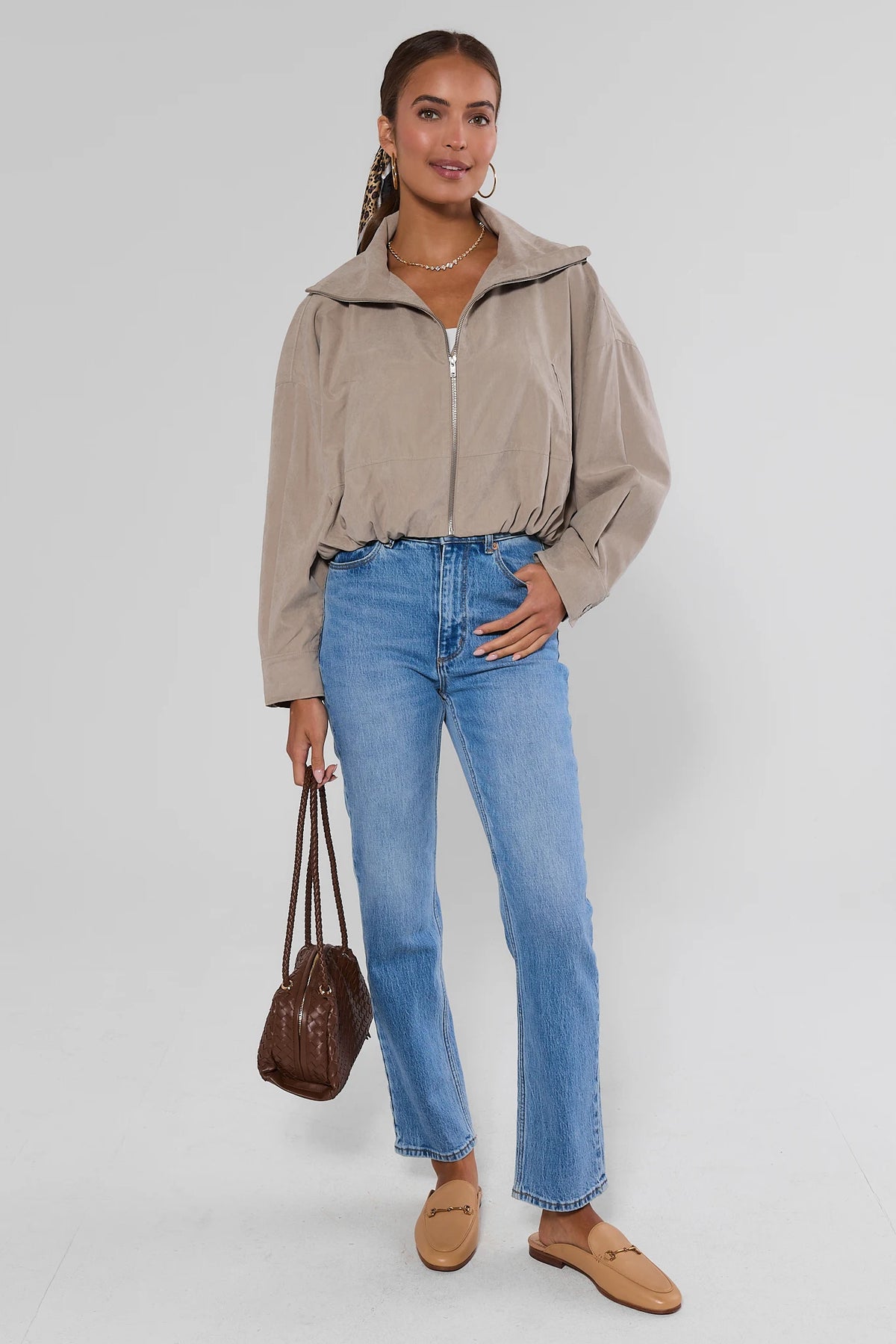 Tan Faux Suede Zip Up Jacket styled with blue jeans, tan loafers, and brown bag - full-length front view | Avara
