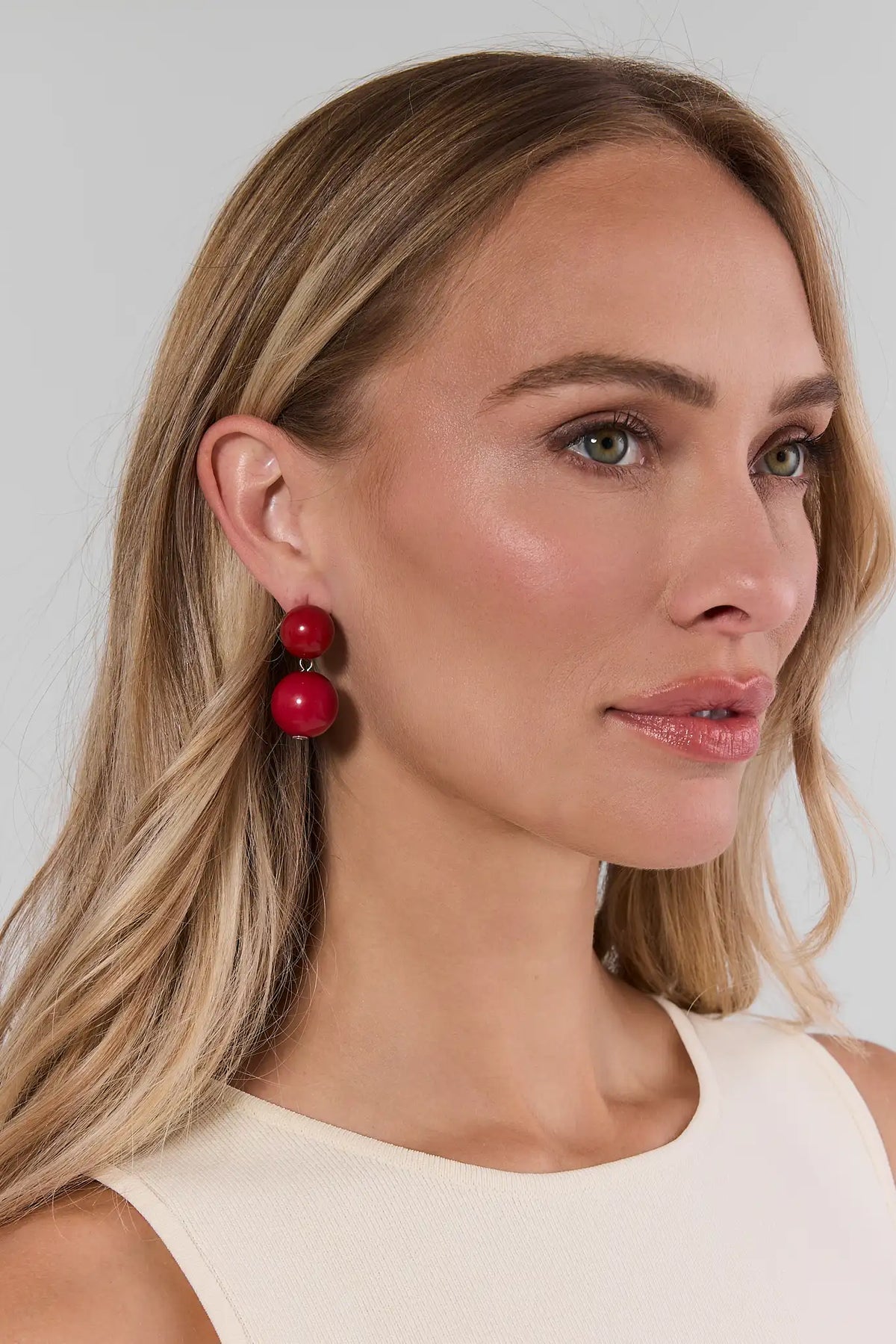 Blonde model wearing maroon acrylic double-drop earrings with gold-tone hardware - On Model Side Profile | Avara