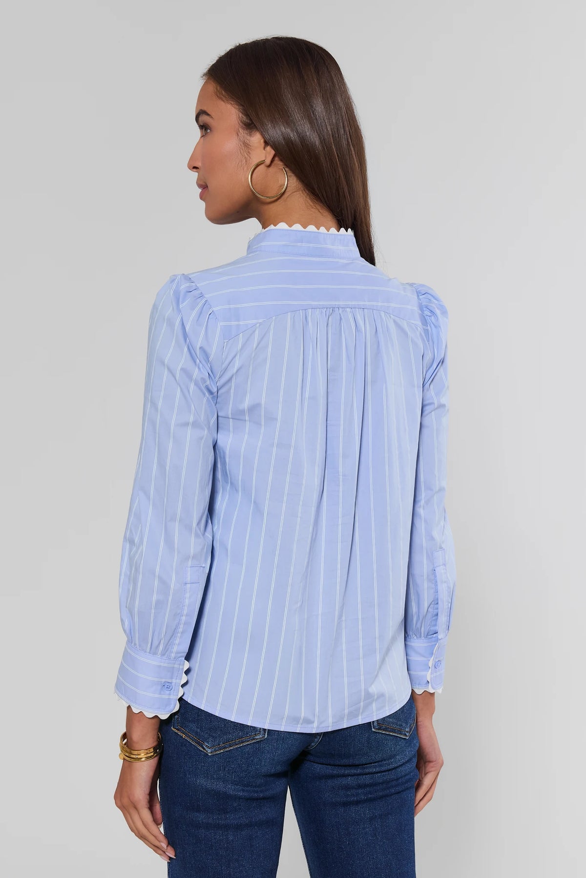 Blue striped ric rac trim top showing gathered back yoke and scalloped cuffs, paired with dark jeans - Back View | Avara