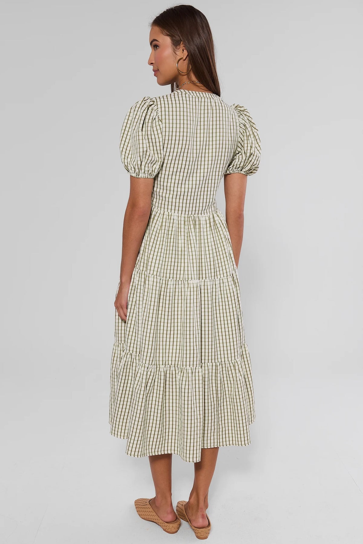 Green plaid split neck midi dress back view showing tiered skirt and puff sleeves, paired with woven flats | Avara