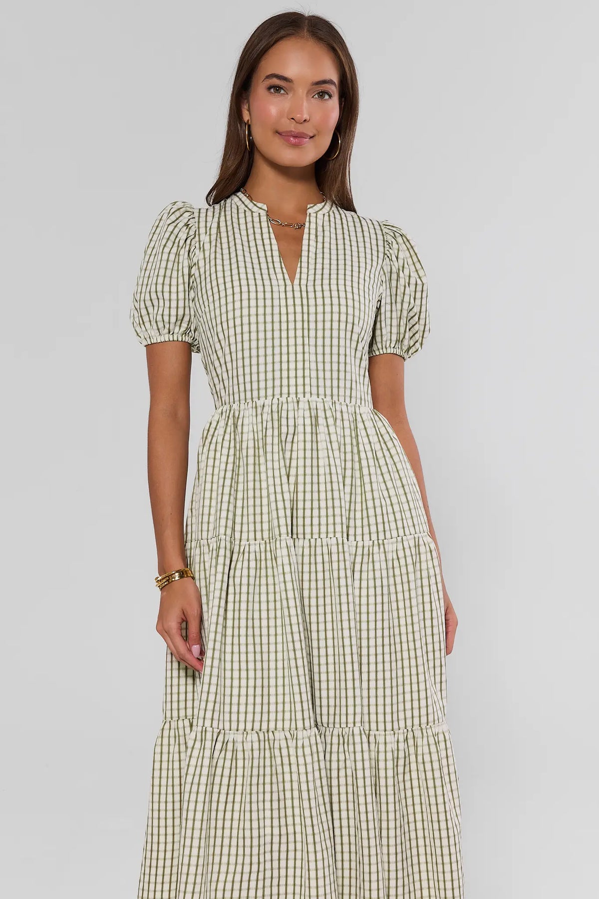Green plaid split neck midi dress with puff sleeves and tiered skirt, front view on model | Avara