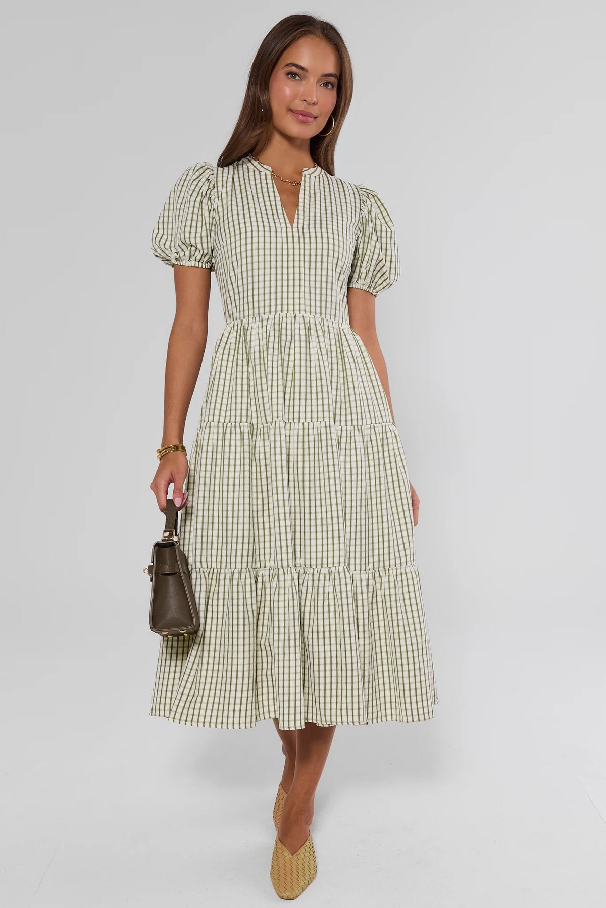 Green plaid tiered midi dress full-length front view, styled with woven flats and brown handbag | Avara