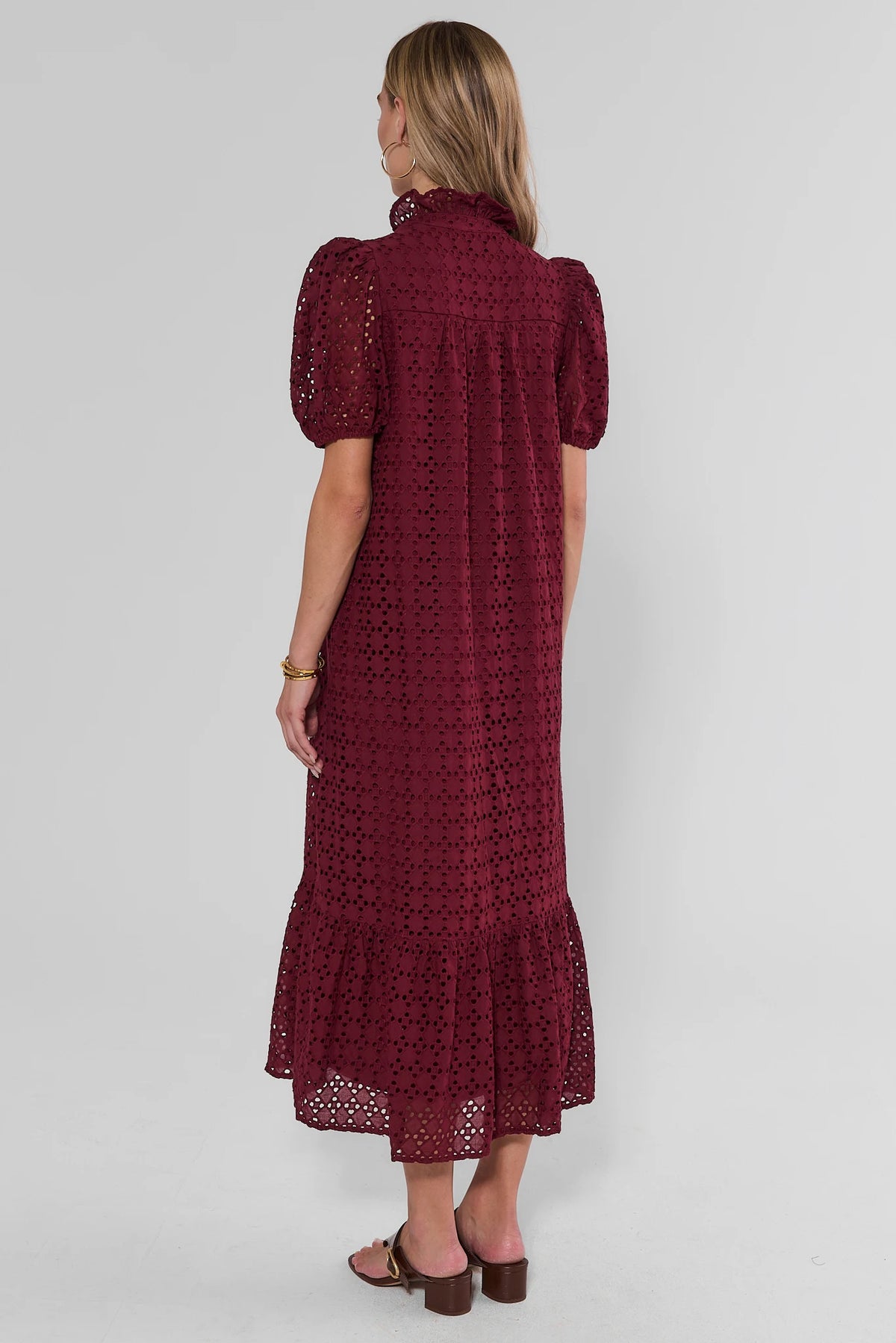Burgundy Eyelet Overlay Maxi Dress back view, ruffled hem and puff sleeves, paired with brown block heels | Avara