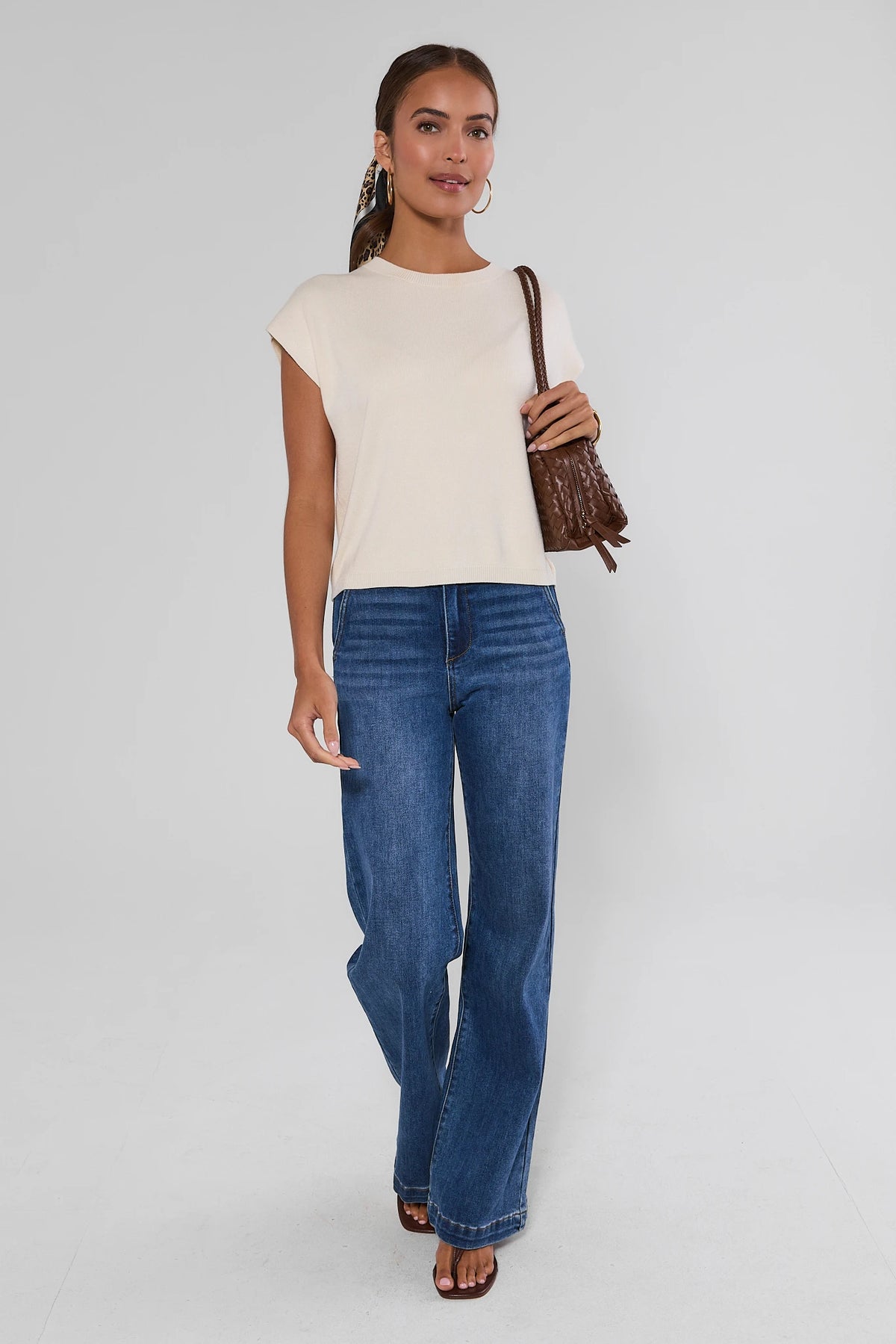 Ivory Knit Crewneck Top full-length styled look with wide-leg jeans and brown woven shoulder bag | Avara