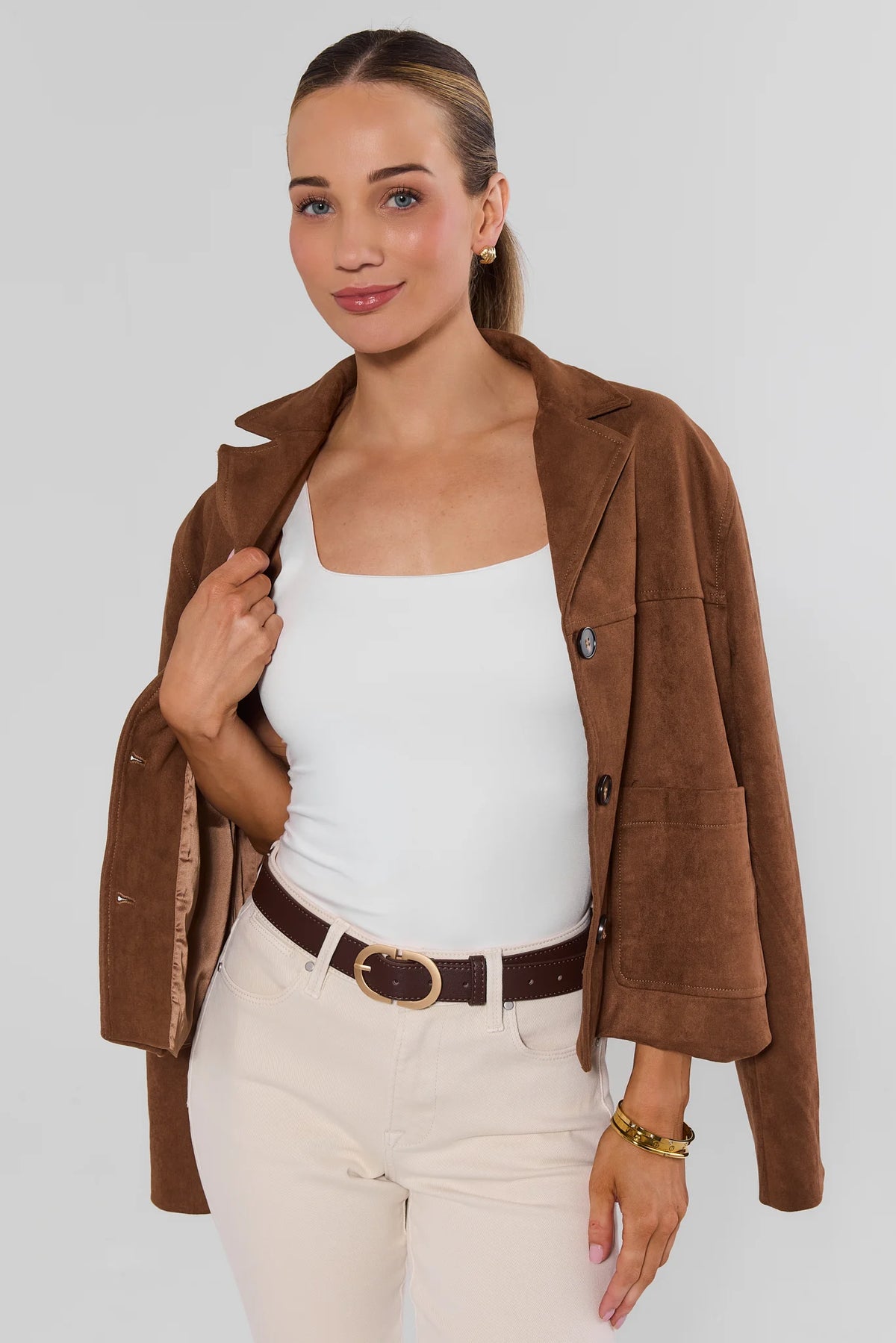Brown Faux Leather Belt styled on model with cream jeans and brown blazer - Styled Look | Avara