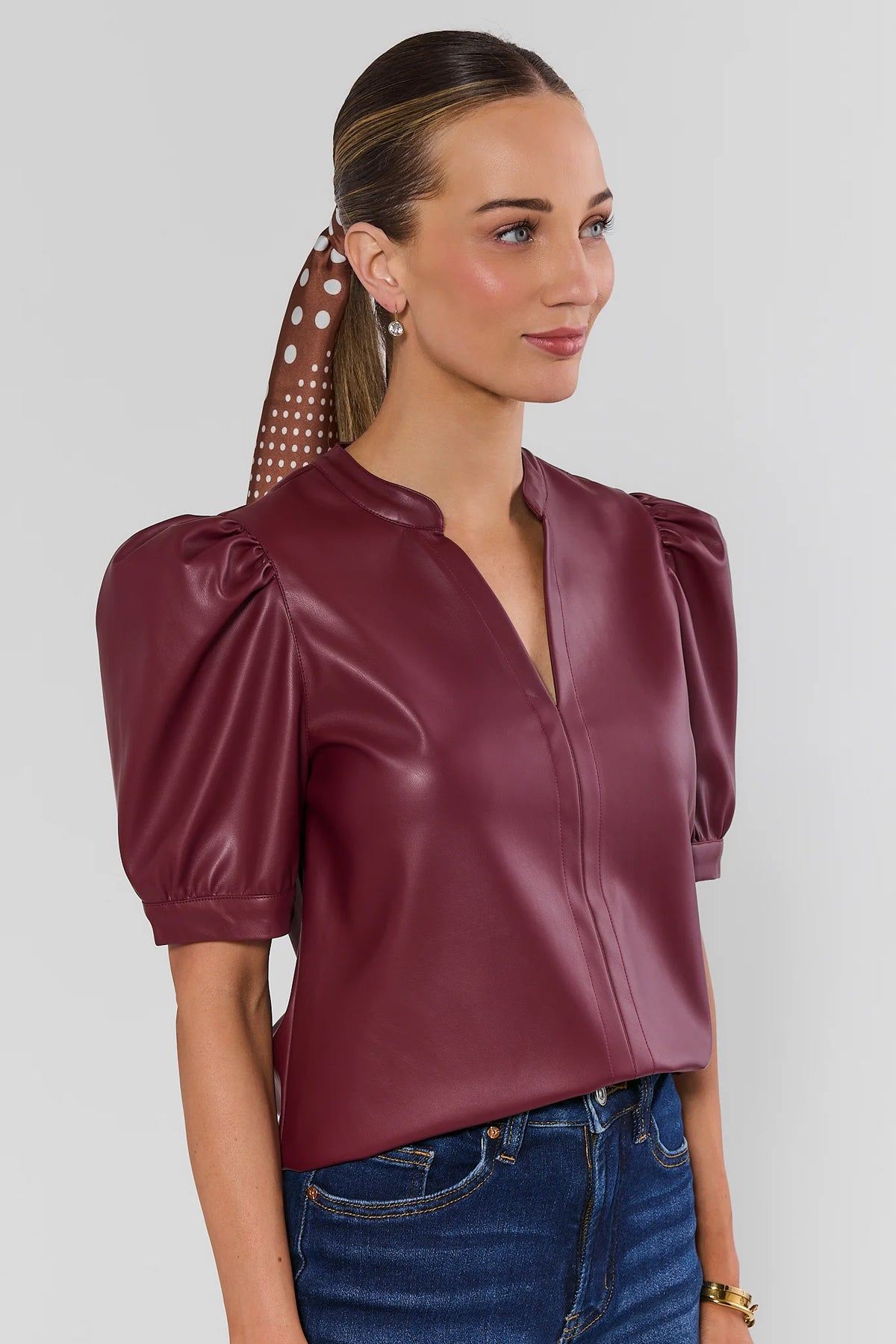 Burgundy Faux Leather Puff Sleeve Top - Side Profile View, Split Neckline and Sleeve Detail | Avara