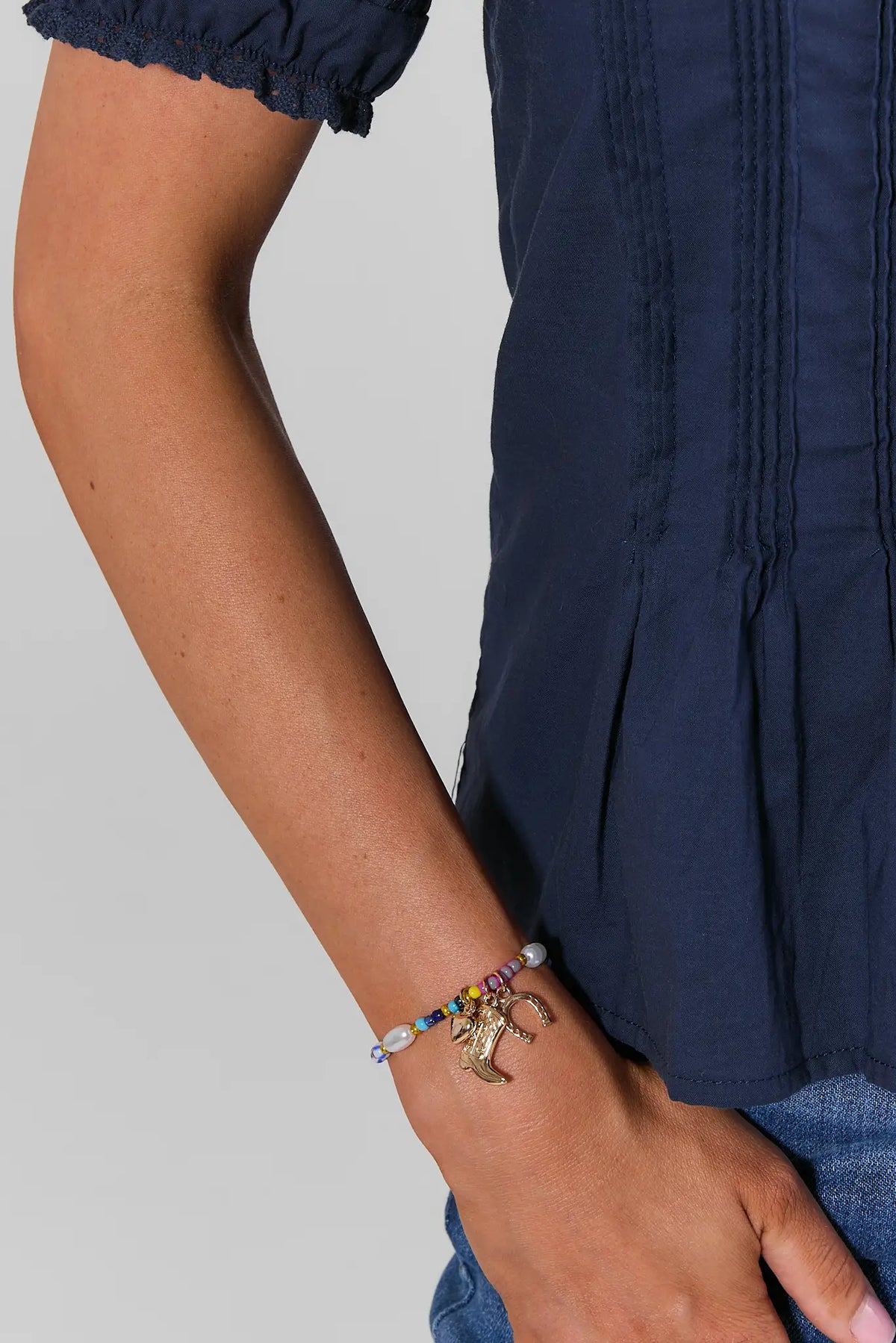 Multicolor Beaded Boot Charm Bracelet with Gold Charms - On Model Wrist Detail | Avara