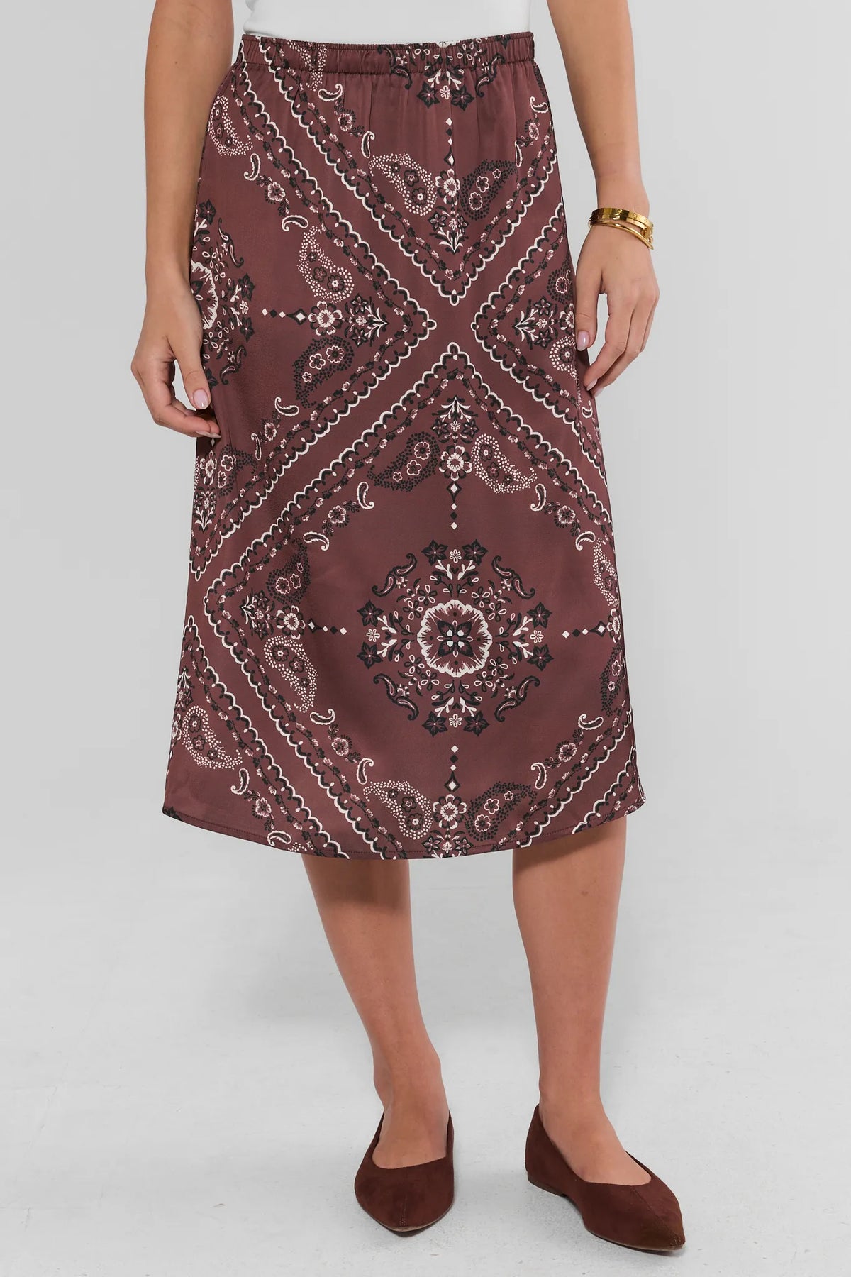 Brown bandana print midi skirt with elastic waist and paisley medallion print - Front View On Model | Avara