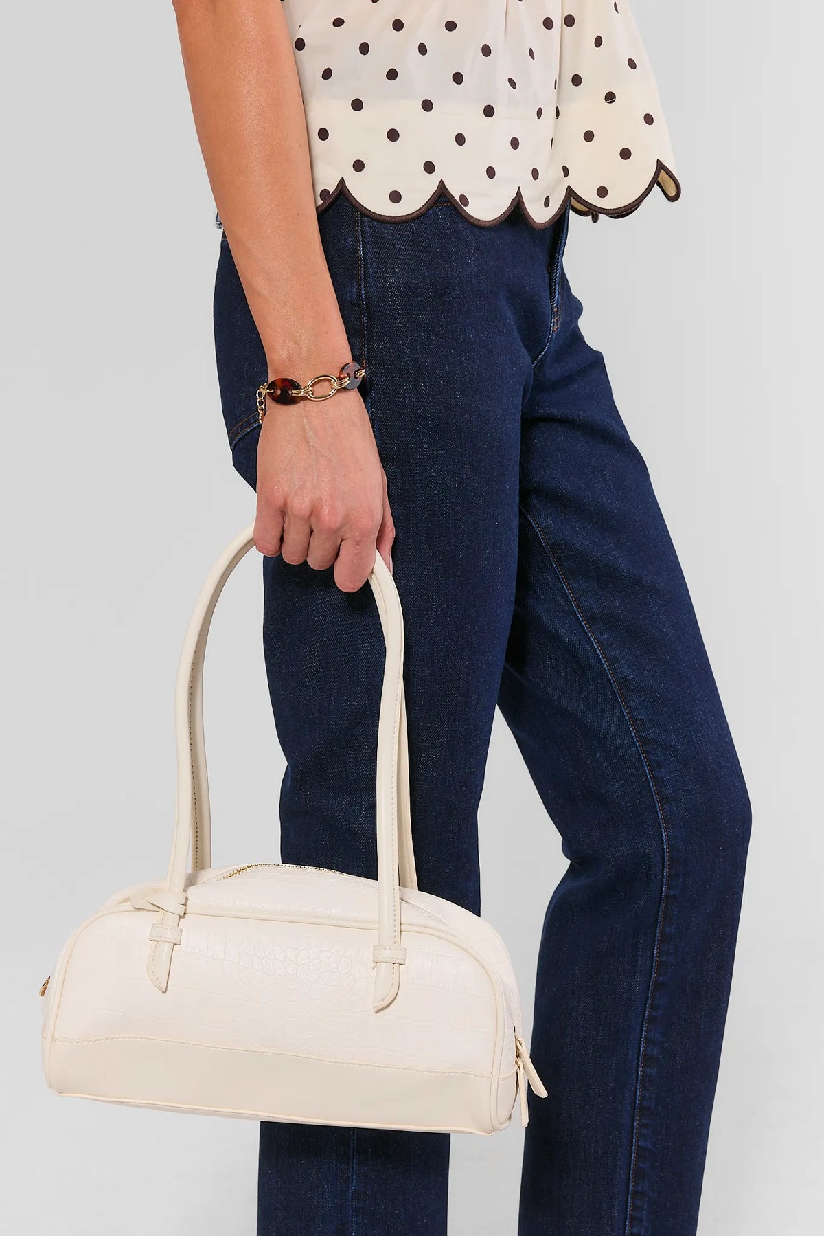 Ivory Textured Faux Leather Bag Styled On Model with Denim - Side View | Avara