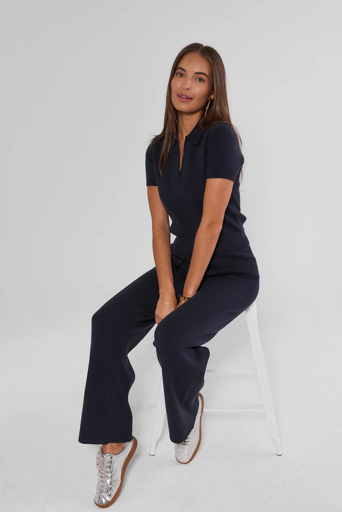 Navy Knit Wide-Leg Pants with Matching Top - Seated Side Profile | Avara