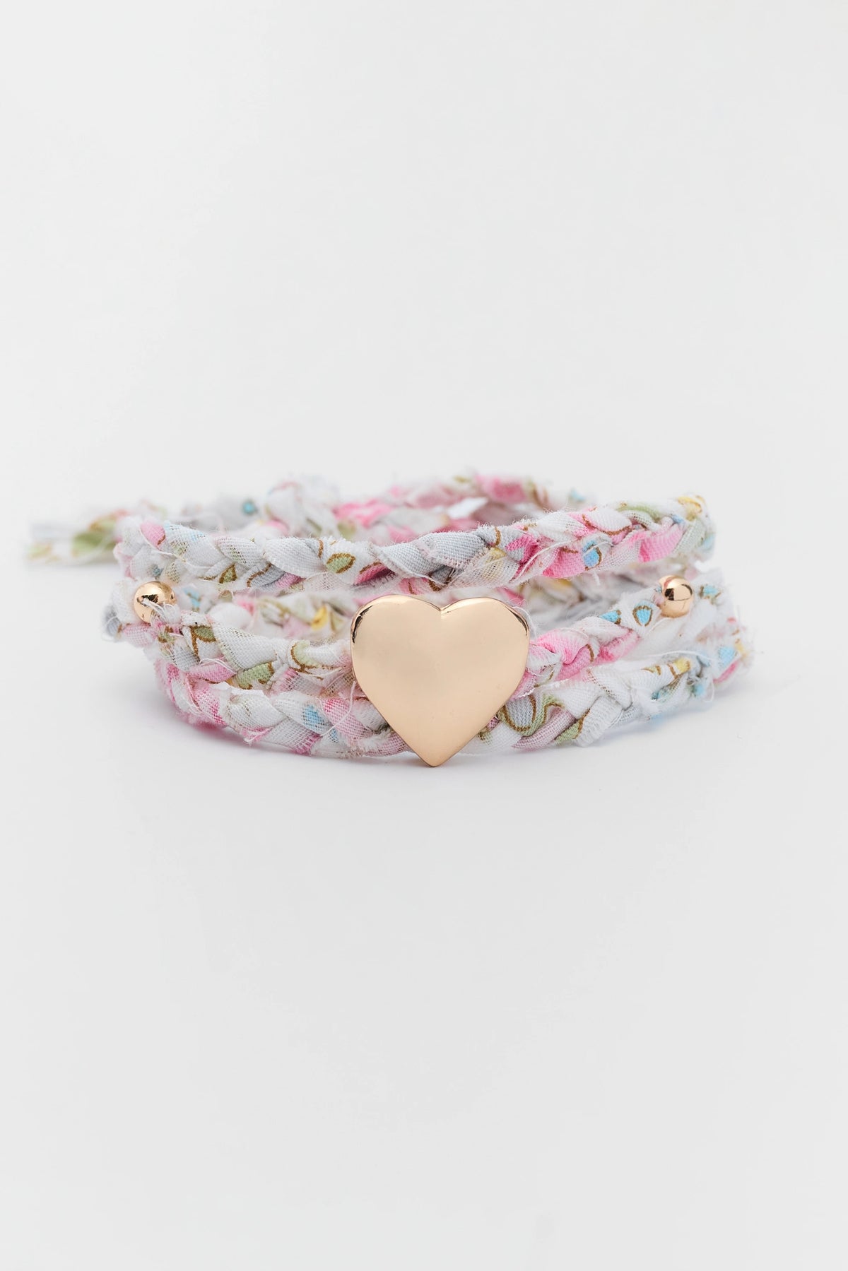 Pink Floral Printed Braided Wrap Bracelet with Gold Heart Charm - Flat Lay | Avara