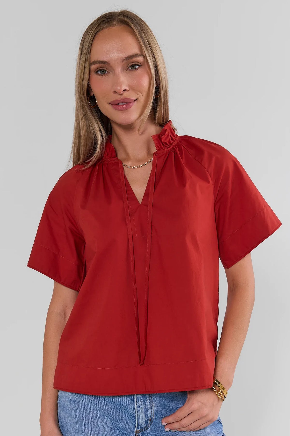 Rust Split Neck Top with Ruffle Collar - Front View, Paired with Jeans | Avara