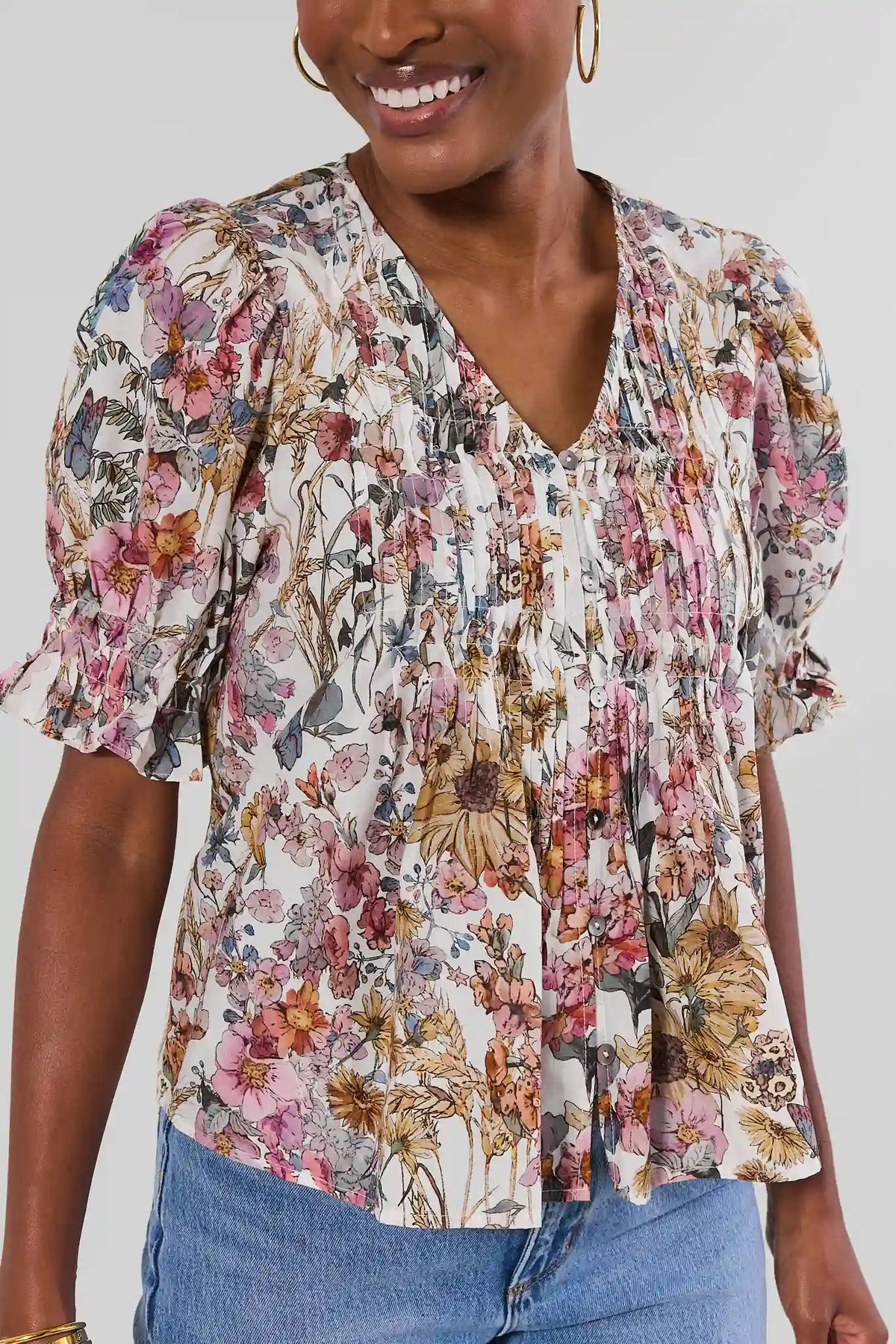 White Floral Printed Pleated Top - Close-Up Detail, V-Neckline and Ruffle Sleeves | Avara